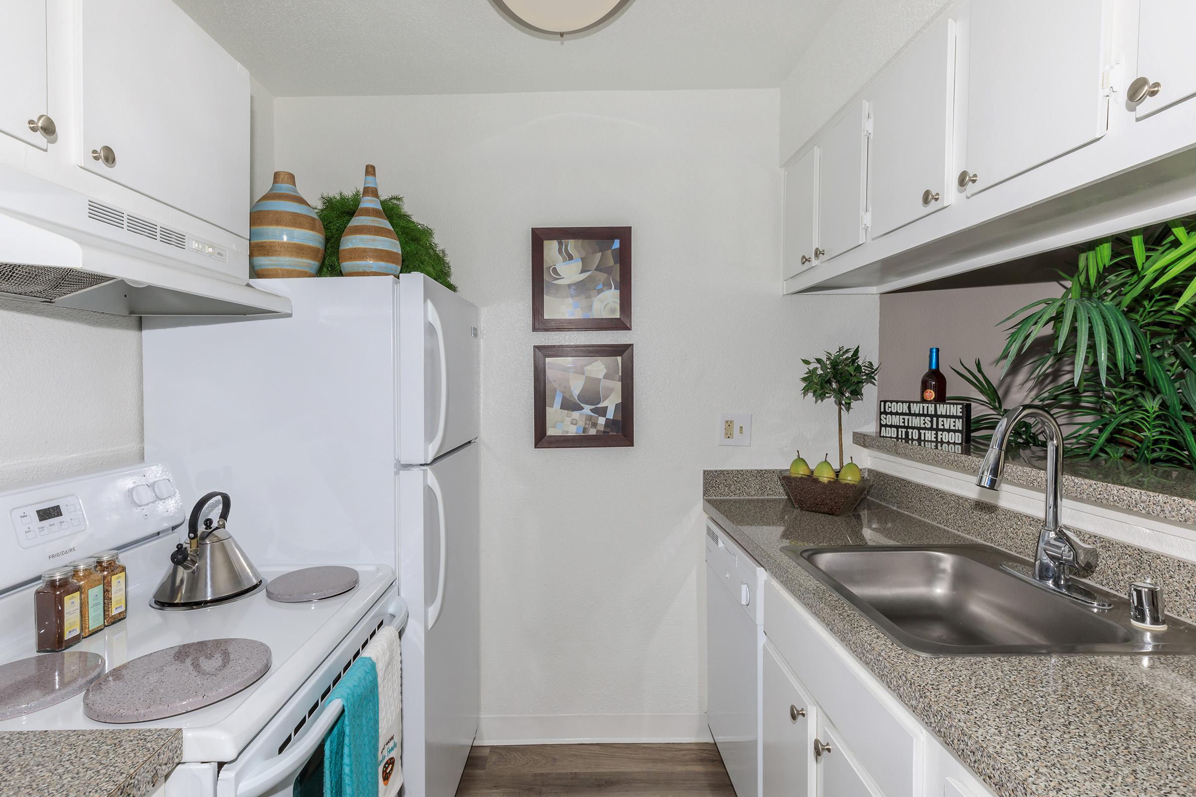 a kitchen with a sink and a mirror