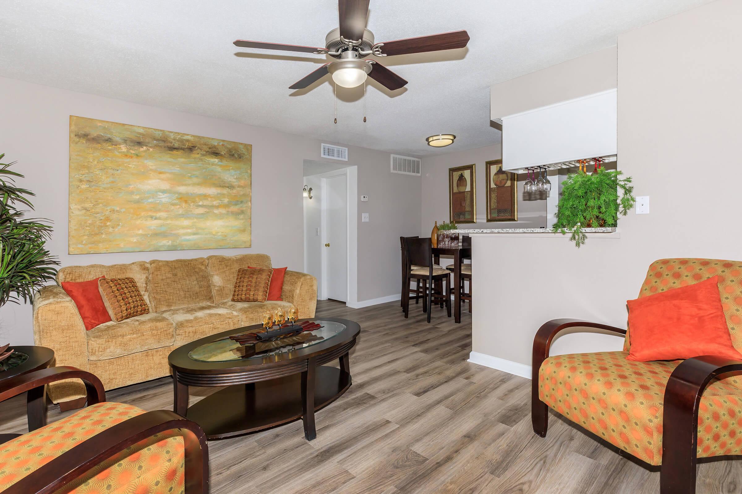 a living room filled with furniture and a flat screen tv