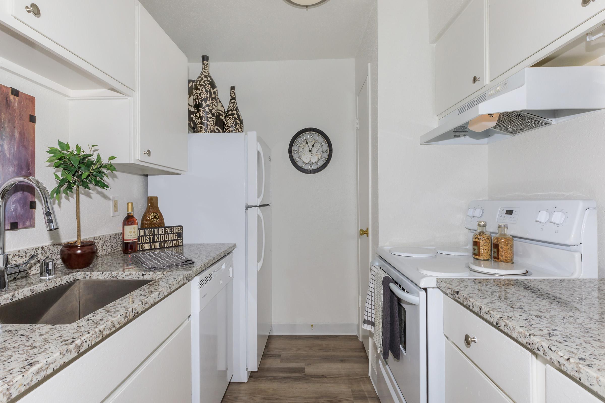 a kitchen with a sink and a mirror