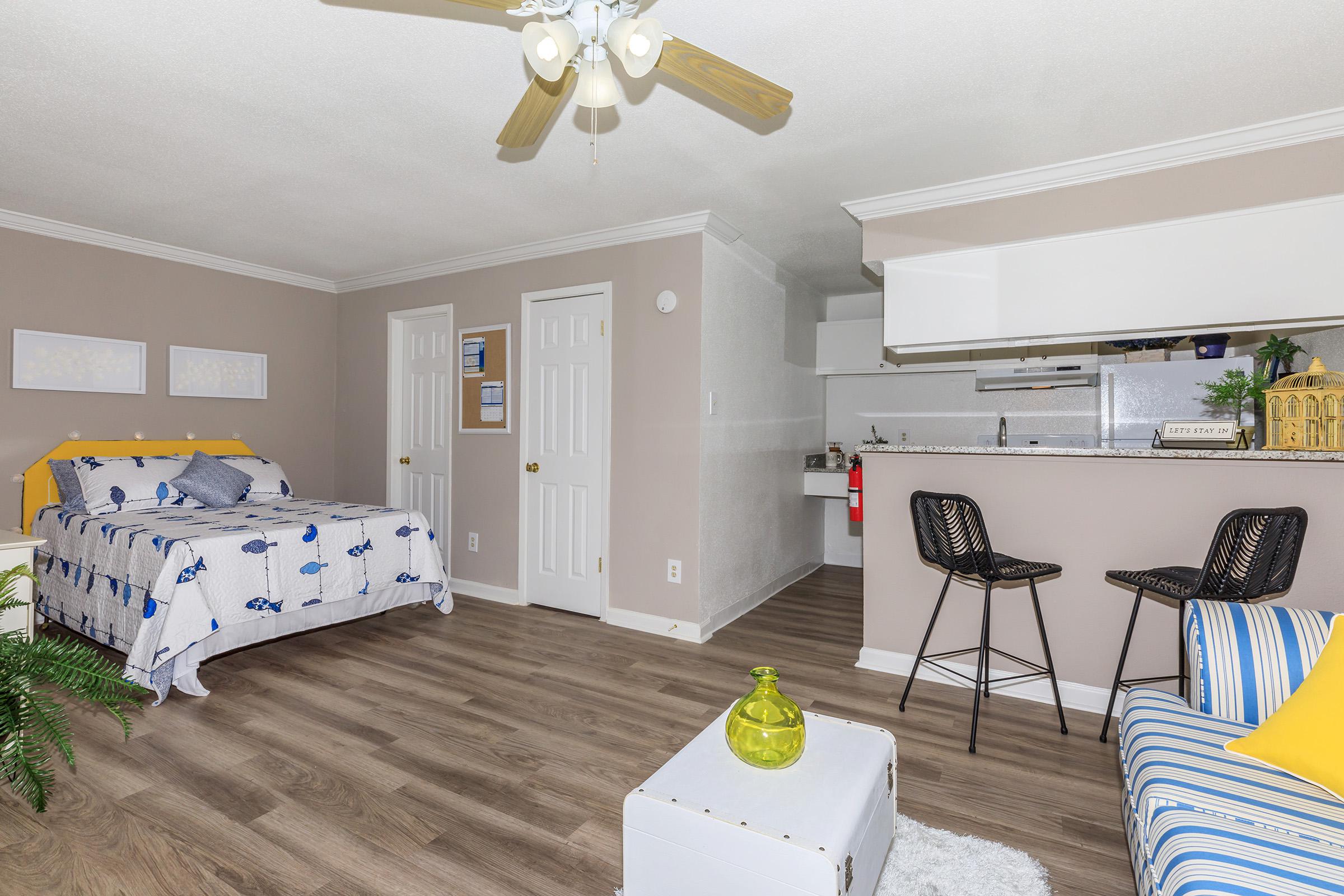 a living room filled with furniture and a bed