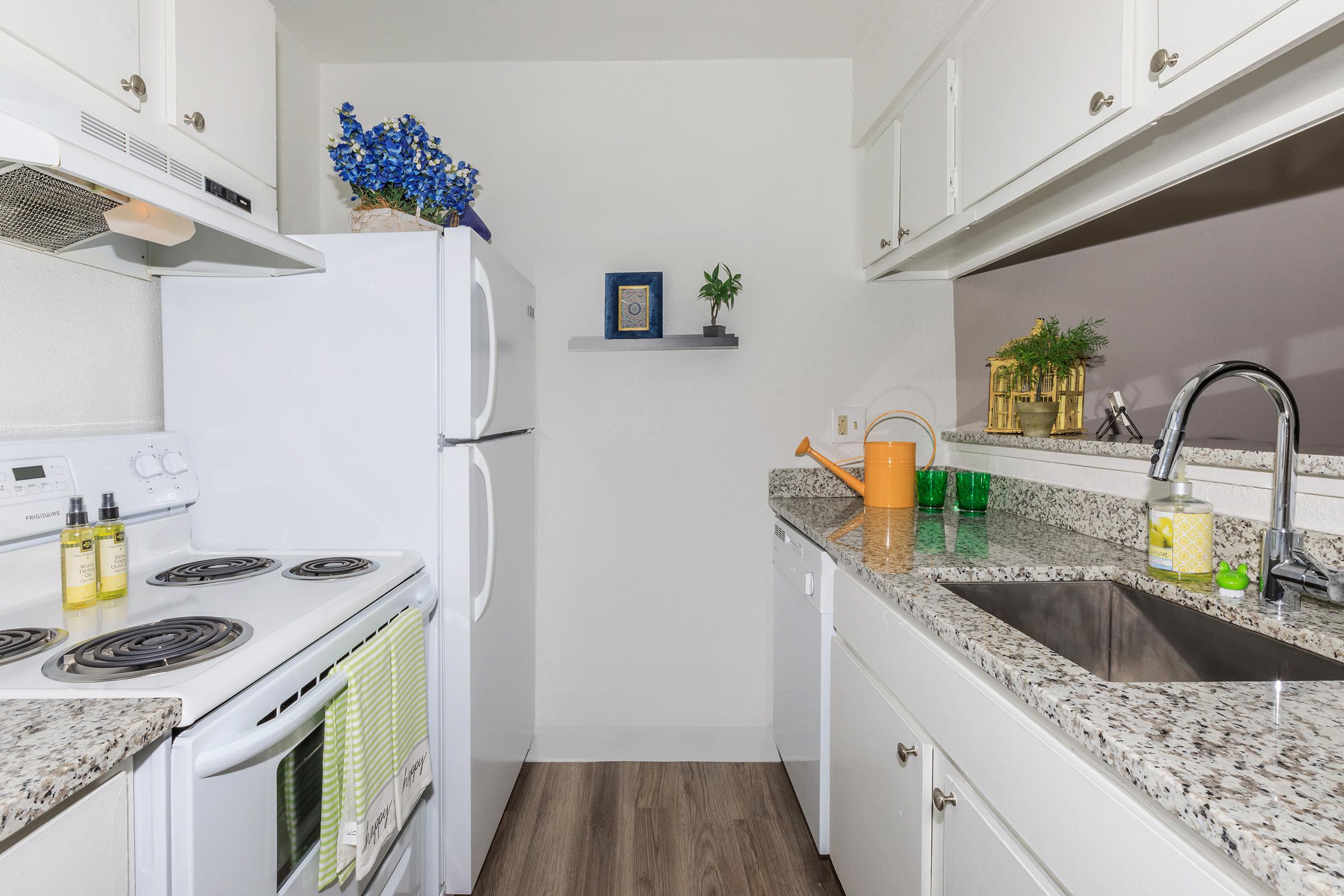 a kitchen with a sink and a mirror