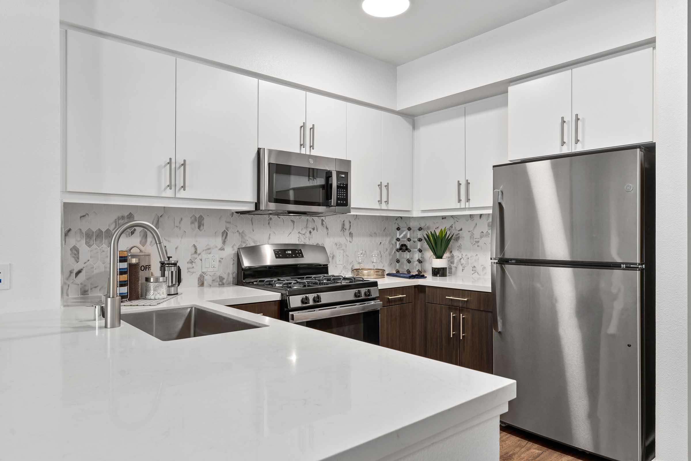 a kitchen with a sink and a refrigerator