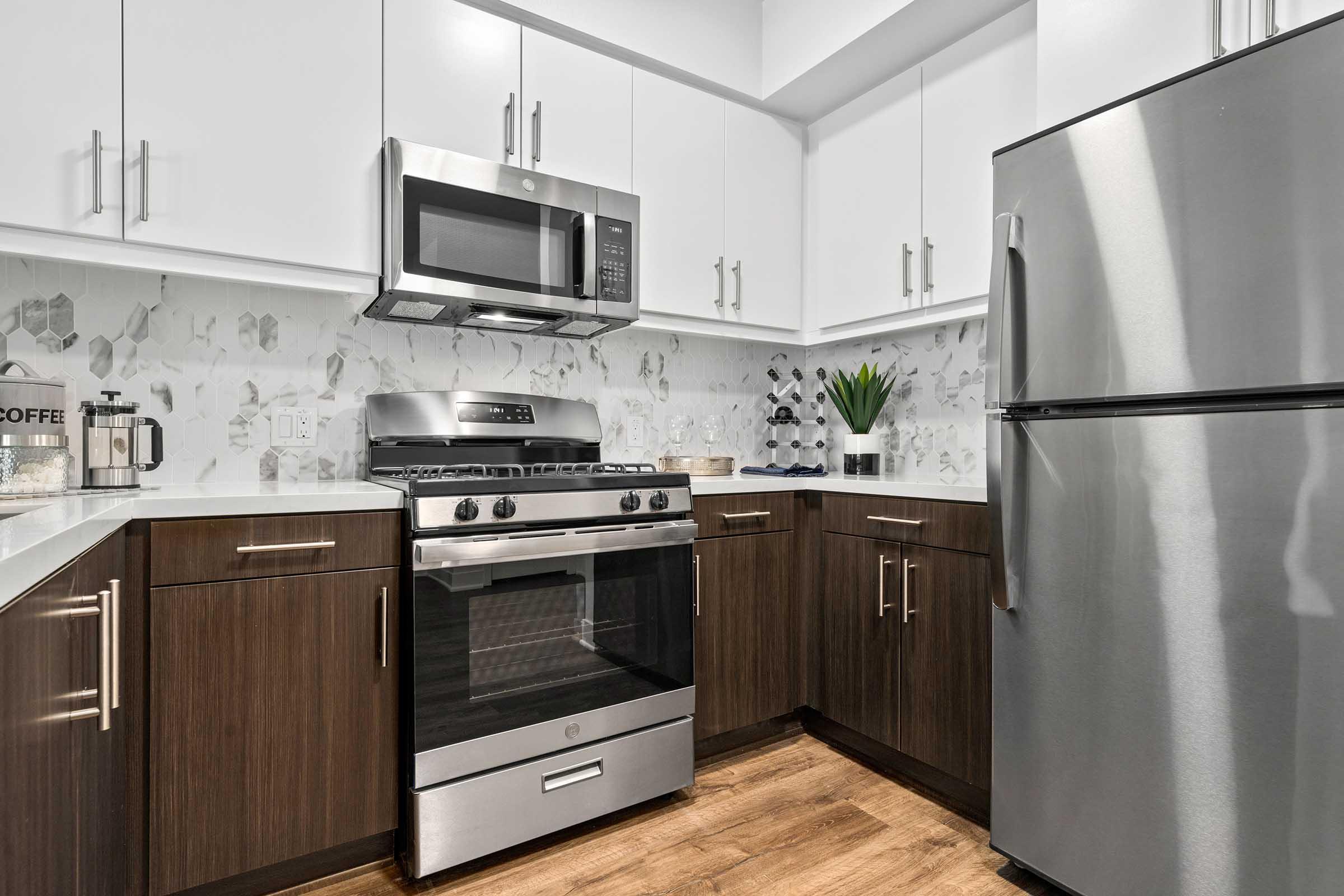 a kitchen with stainless steel appliances and wooden cabinets