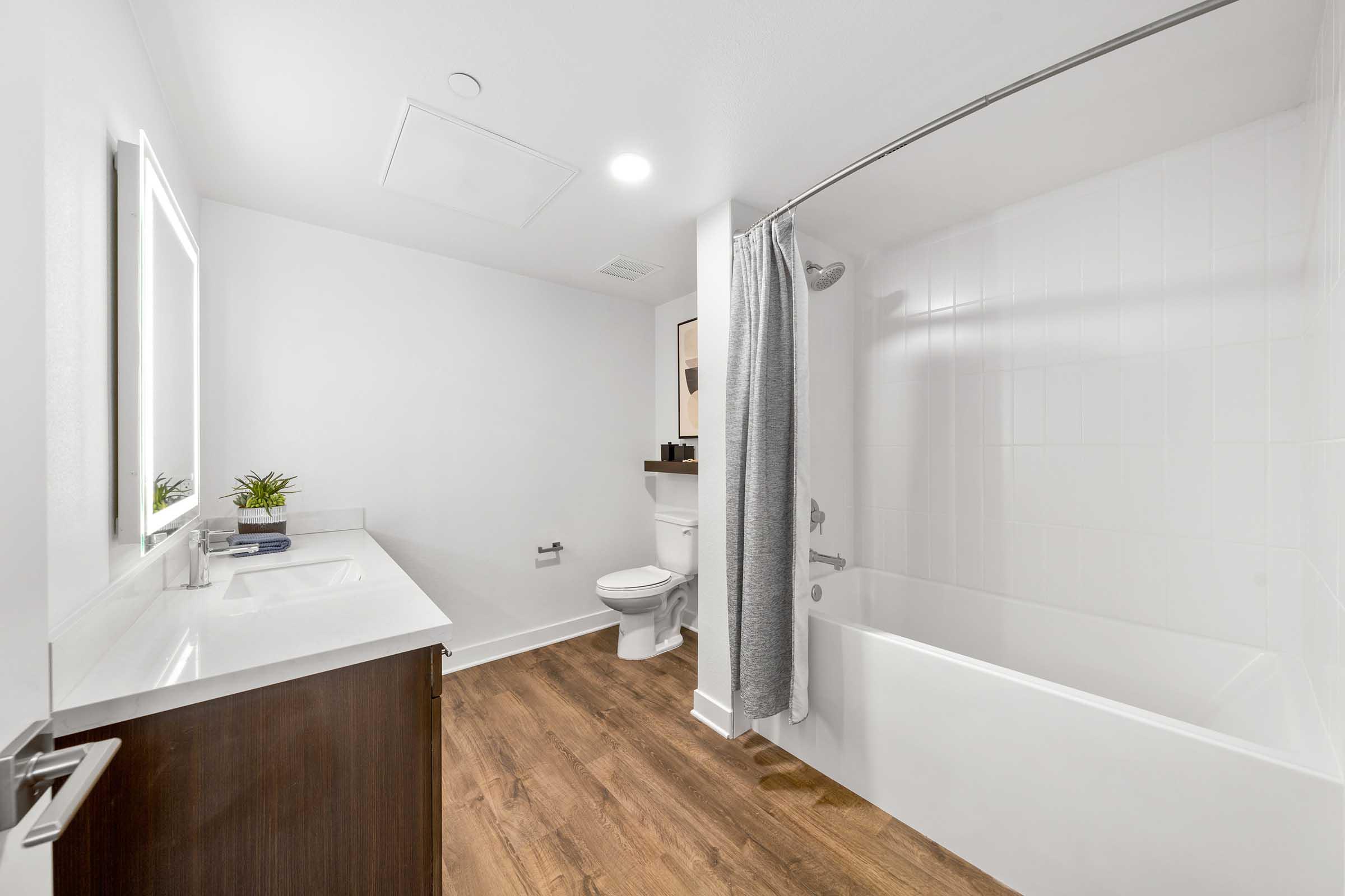 a room with a sink and a bathtub