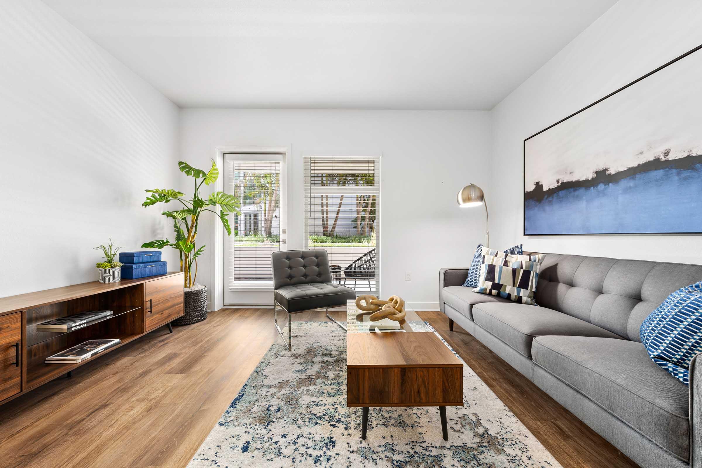 a living room filled with furniture and a large window