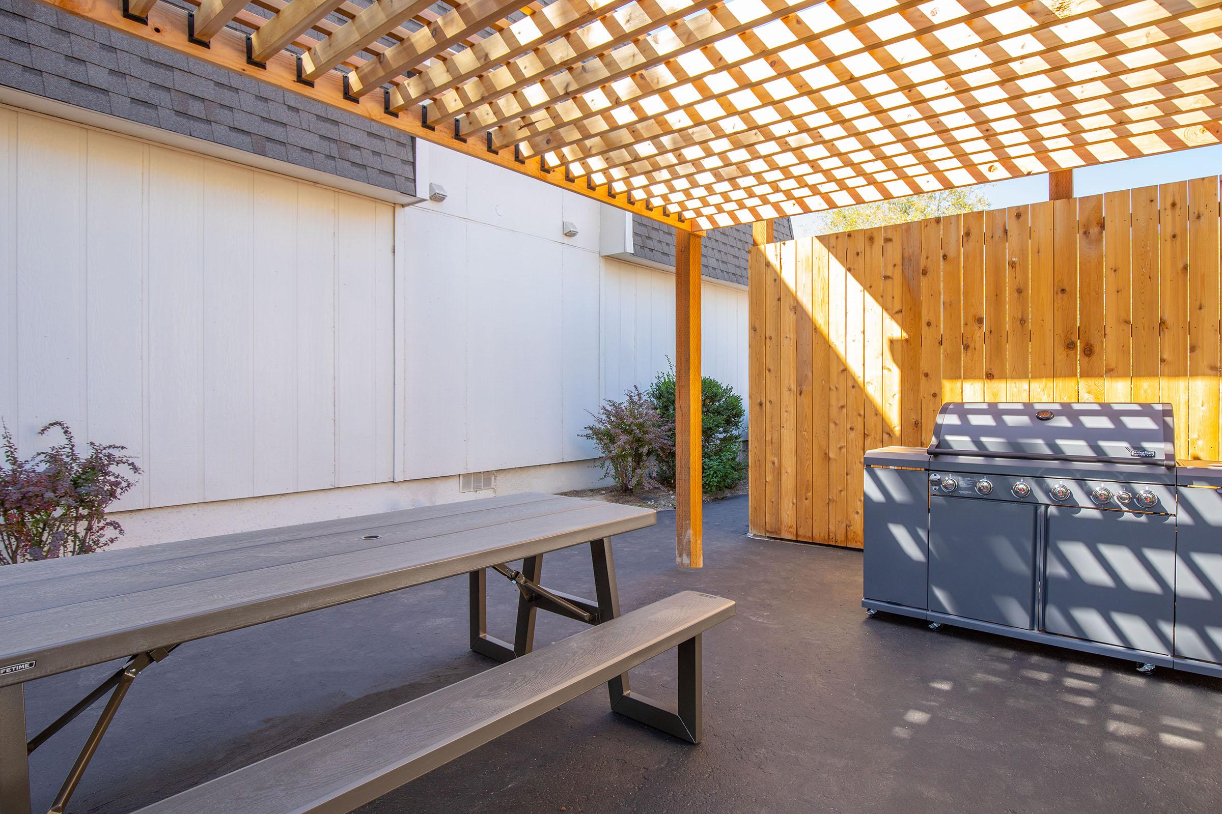 a wooden bench on the side of a building