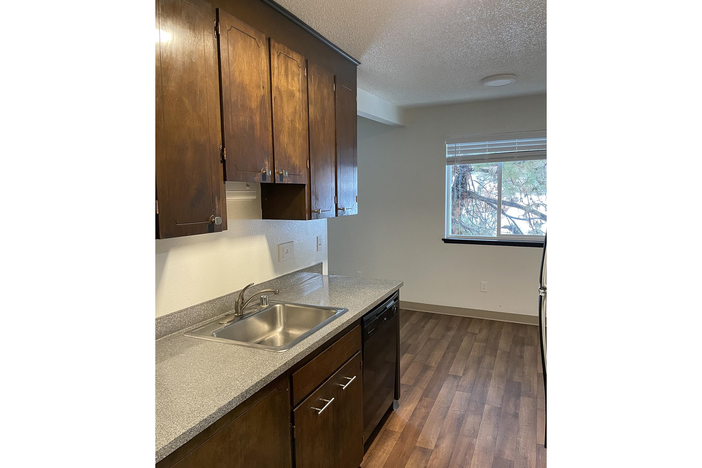 a kitchen with a sink and a mirror