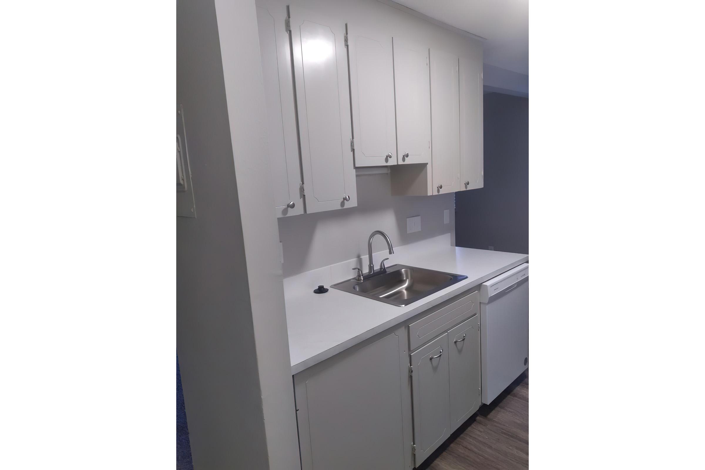 a kitchen with a sink and a mirror