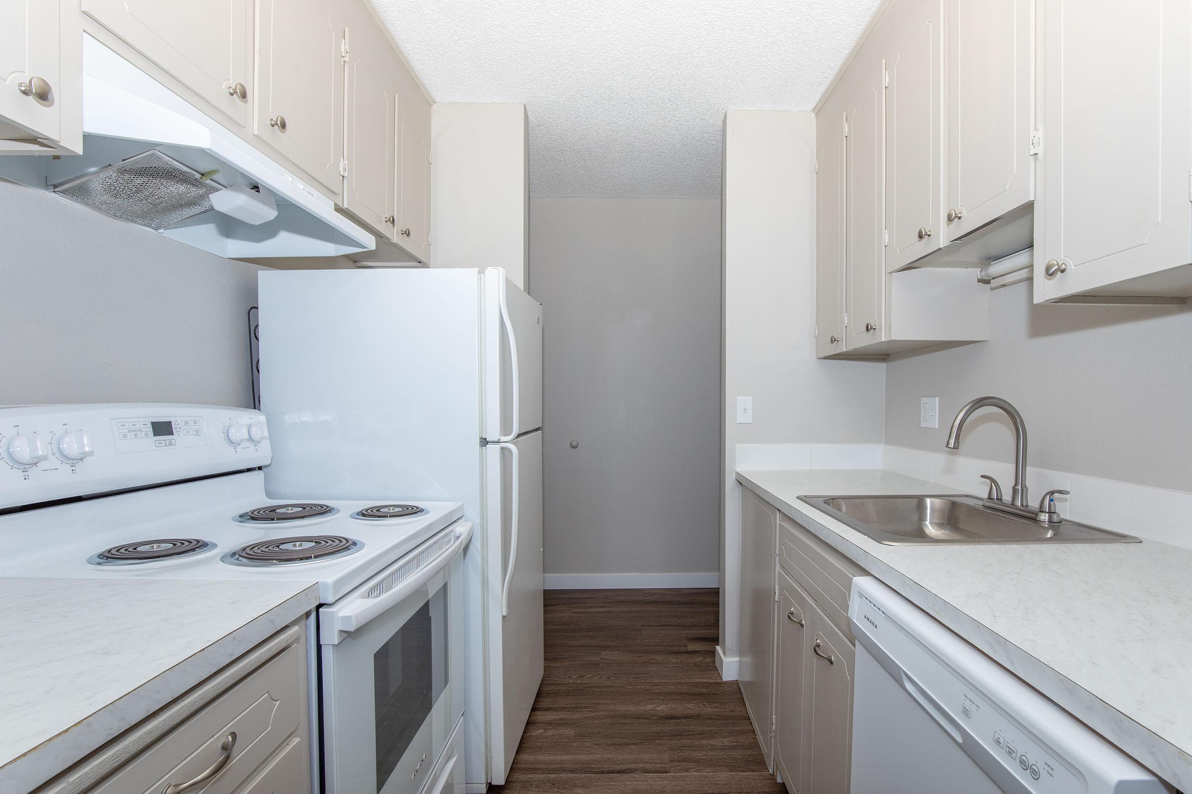 a kitchen with a stove and a sink