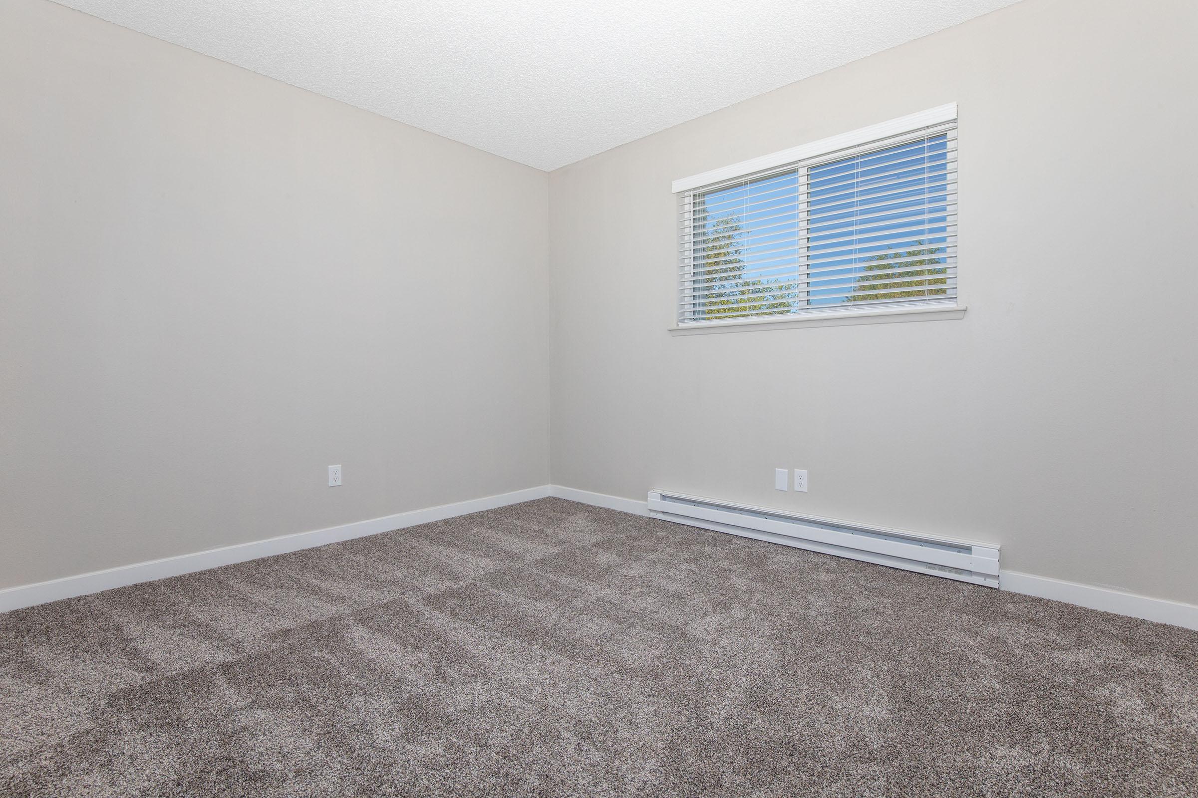 a bedroom with a large window