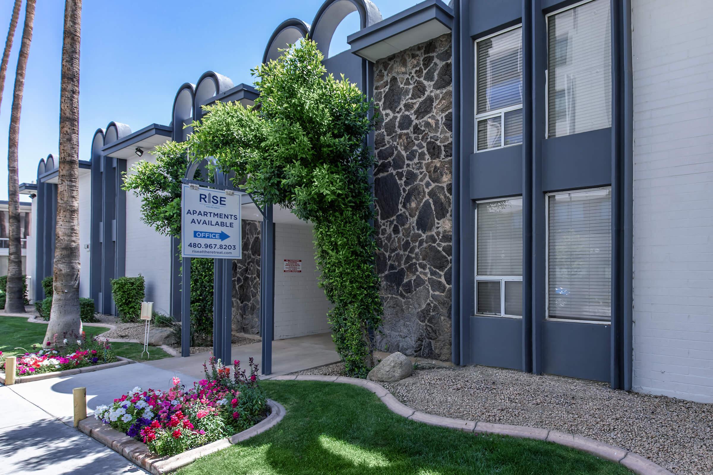 a close up of a flower garden in front of a building