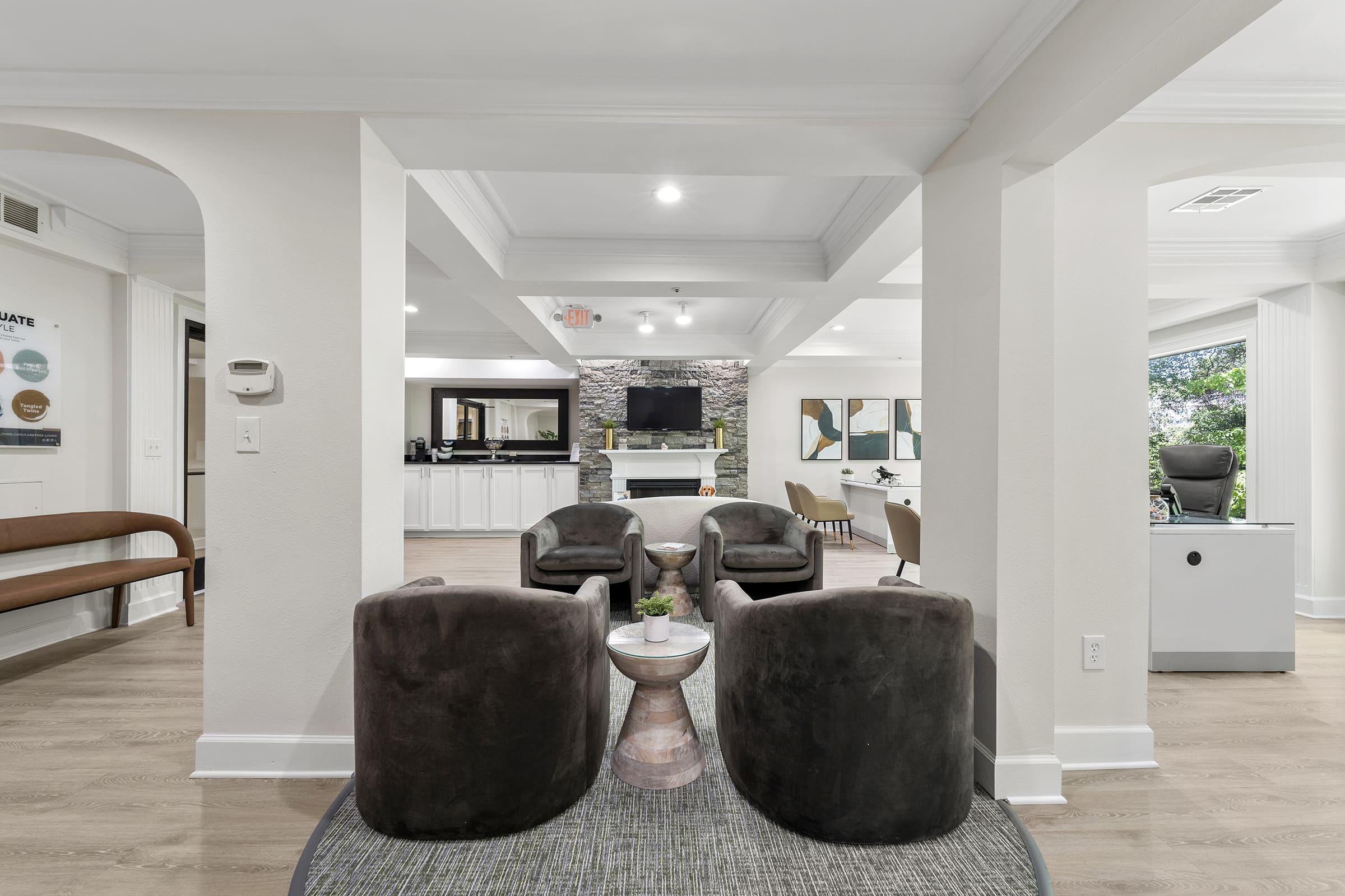 a living room filled with furniture and a large window