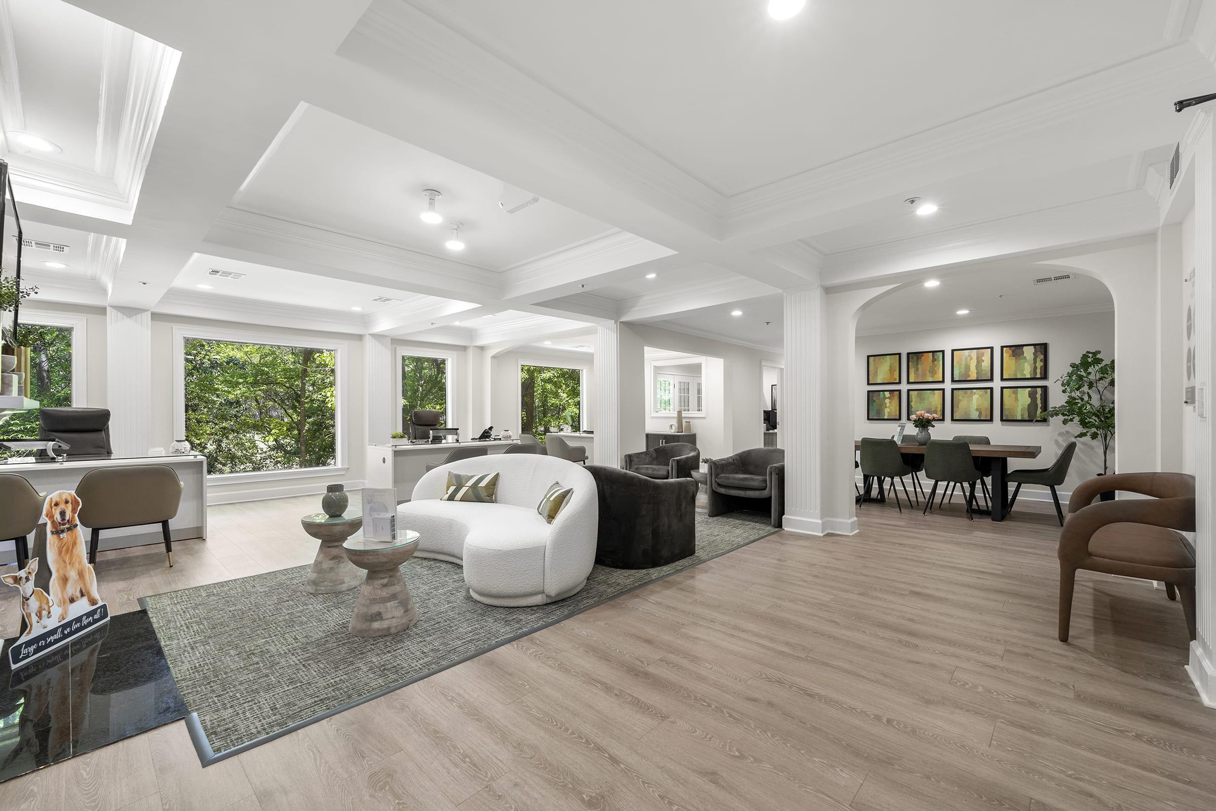 a living room filled with furniture and a large window