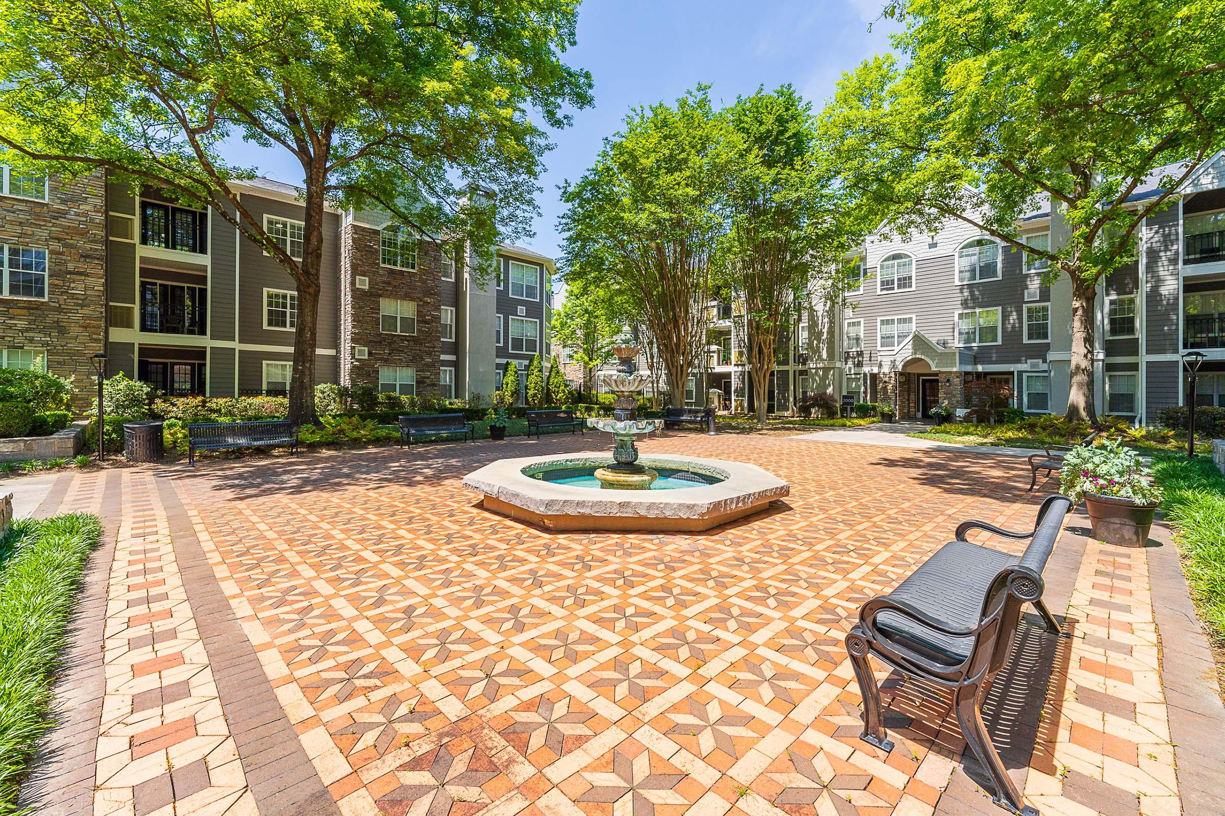 a garden in front of a brick building