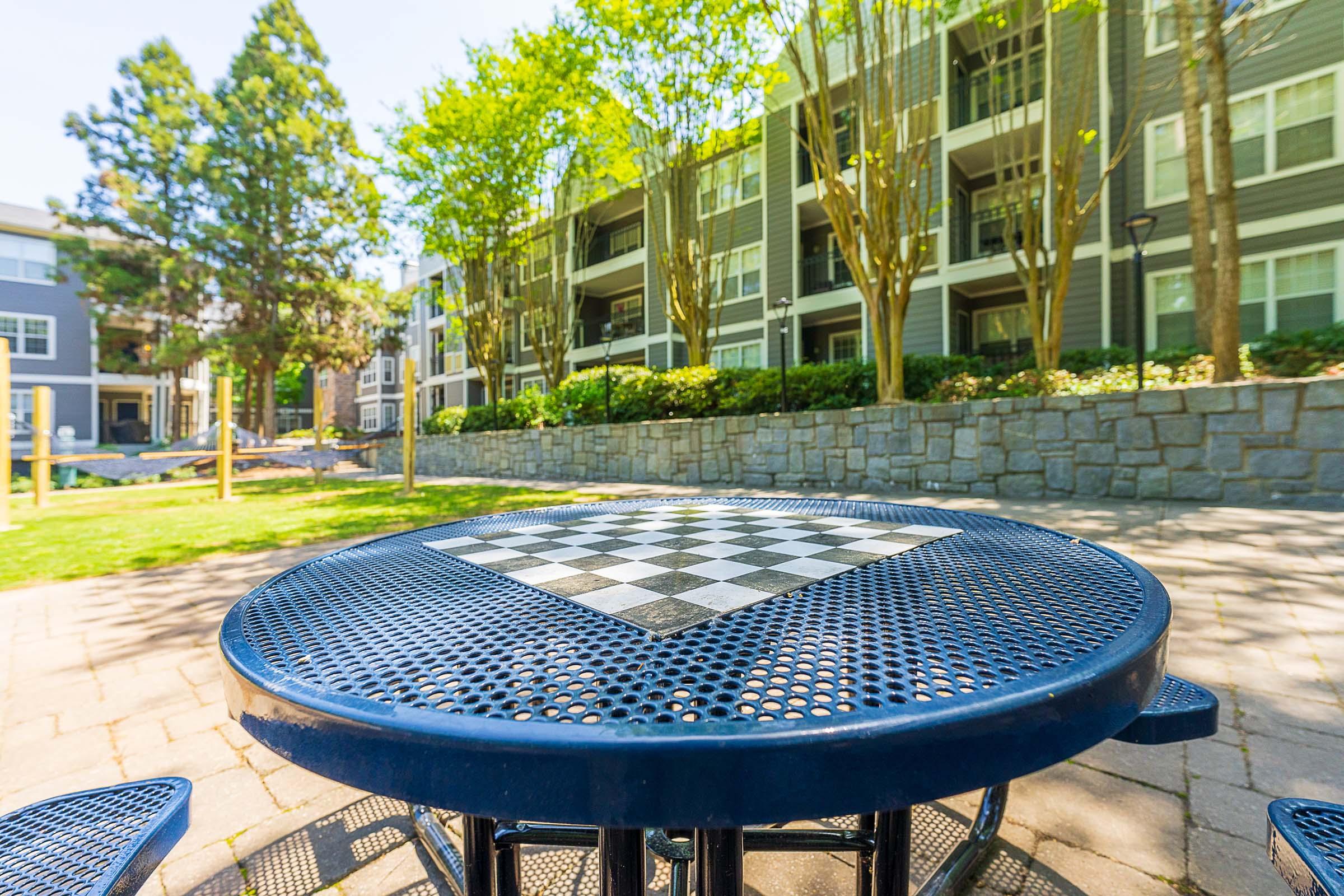 a couple of lawn chairs sitting on top of a picnic table