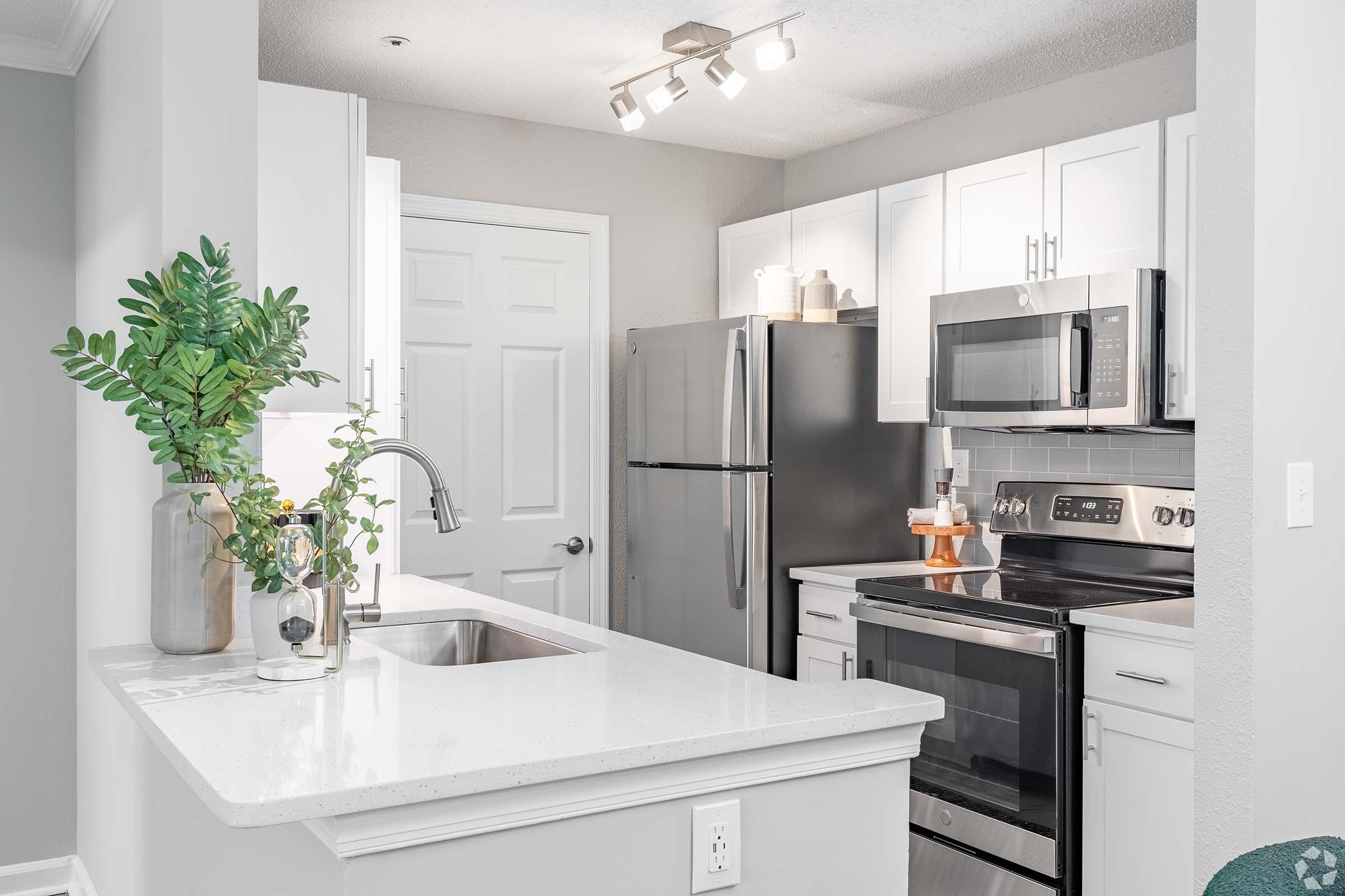 a kitchen with a sink and a mirror