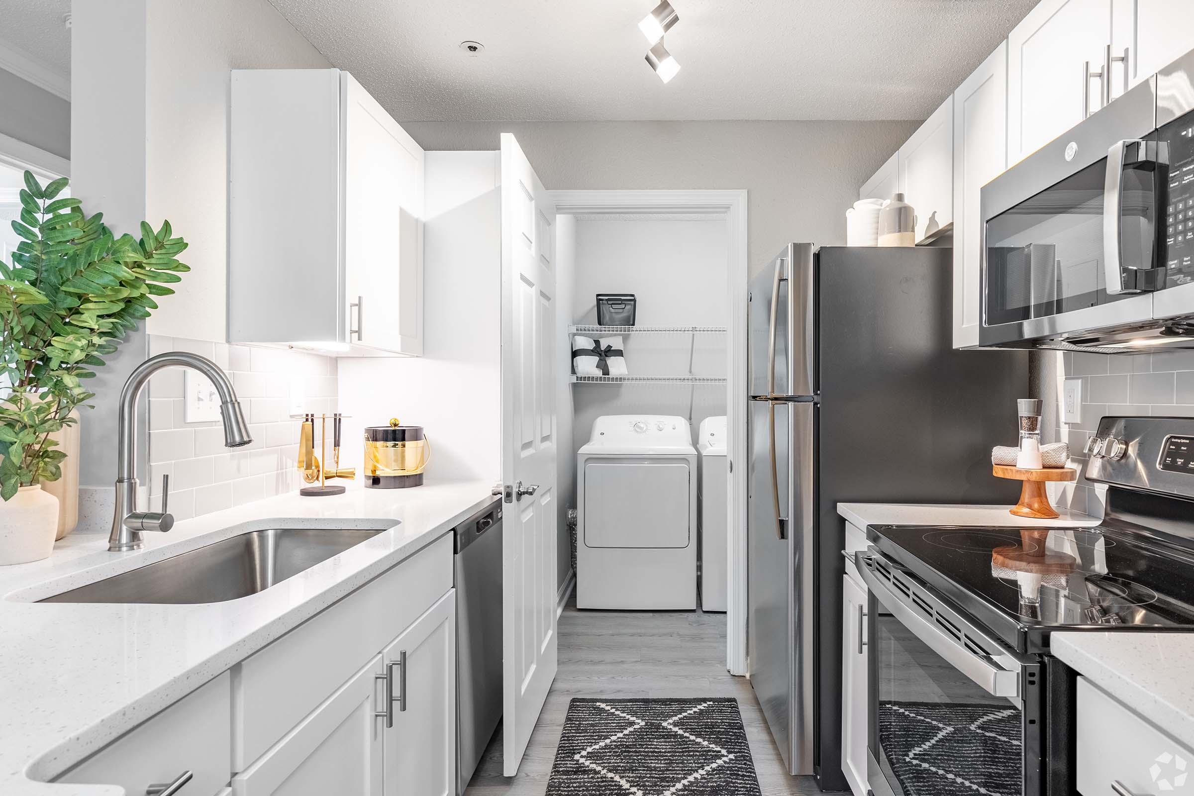 a kitchen with a sink and a refrigerator