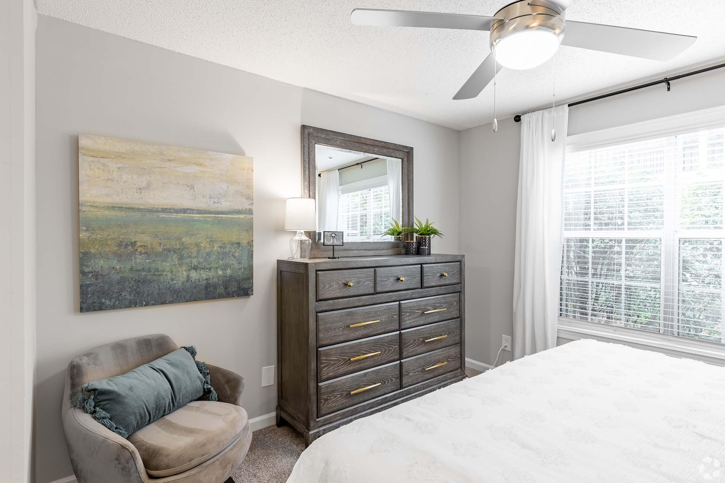 a living room with a bed and a window