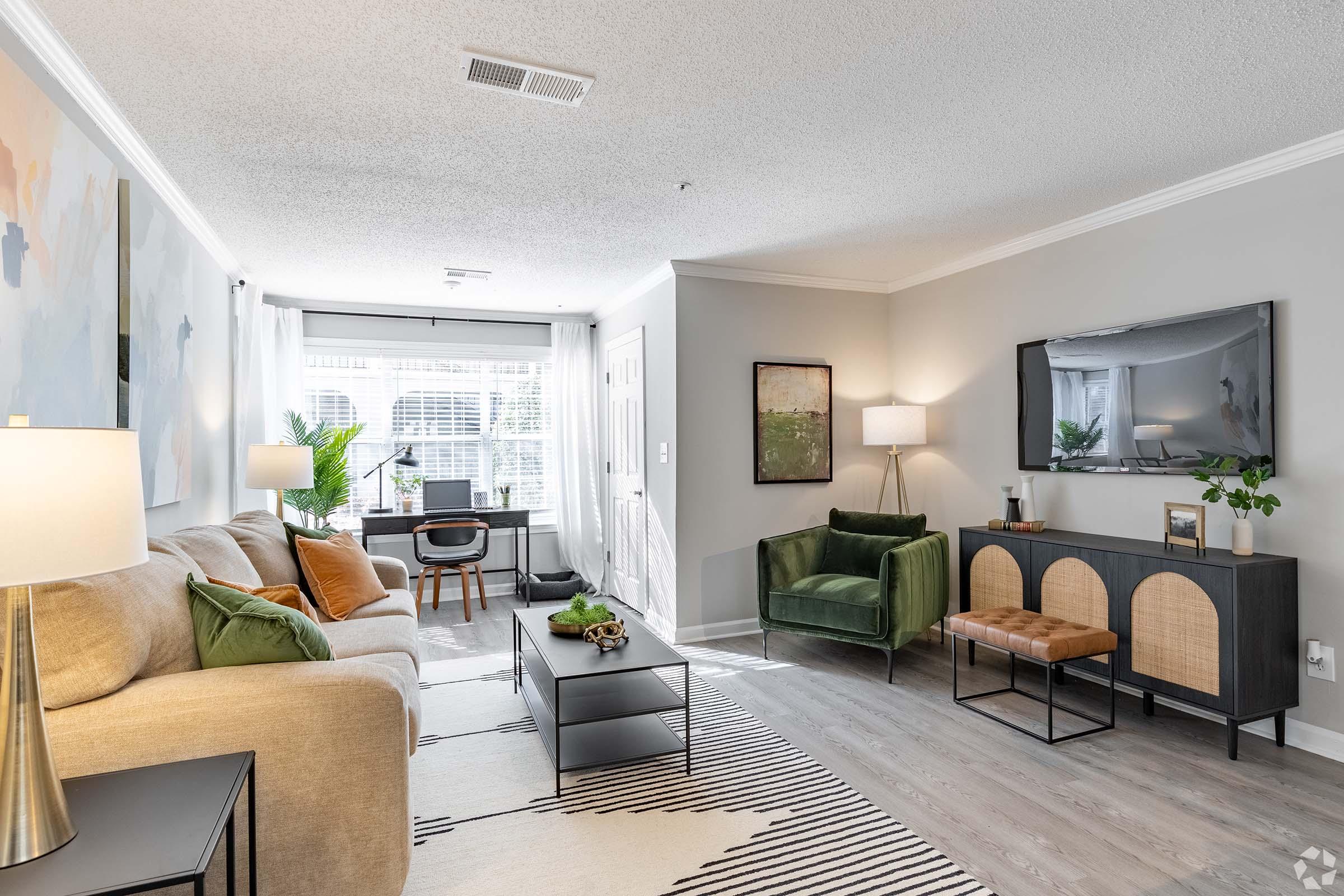 a living room filled with furniture and a large window