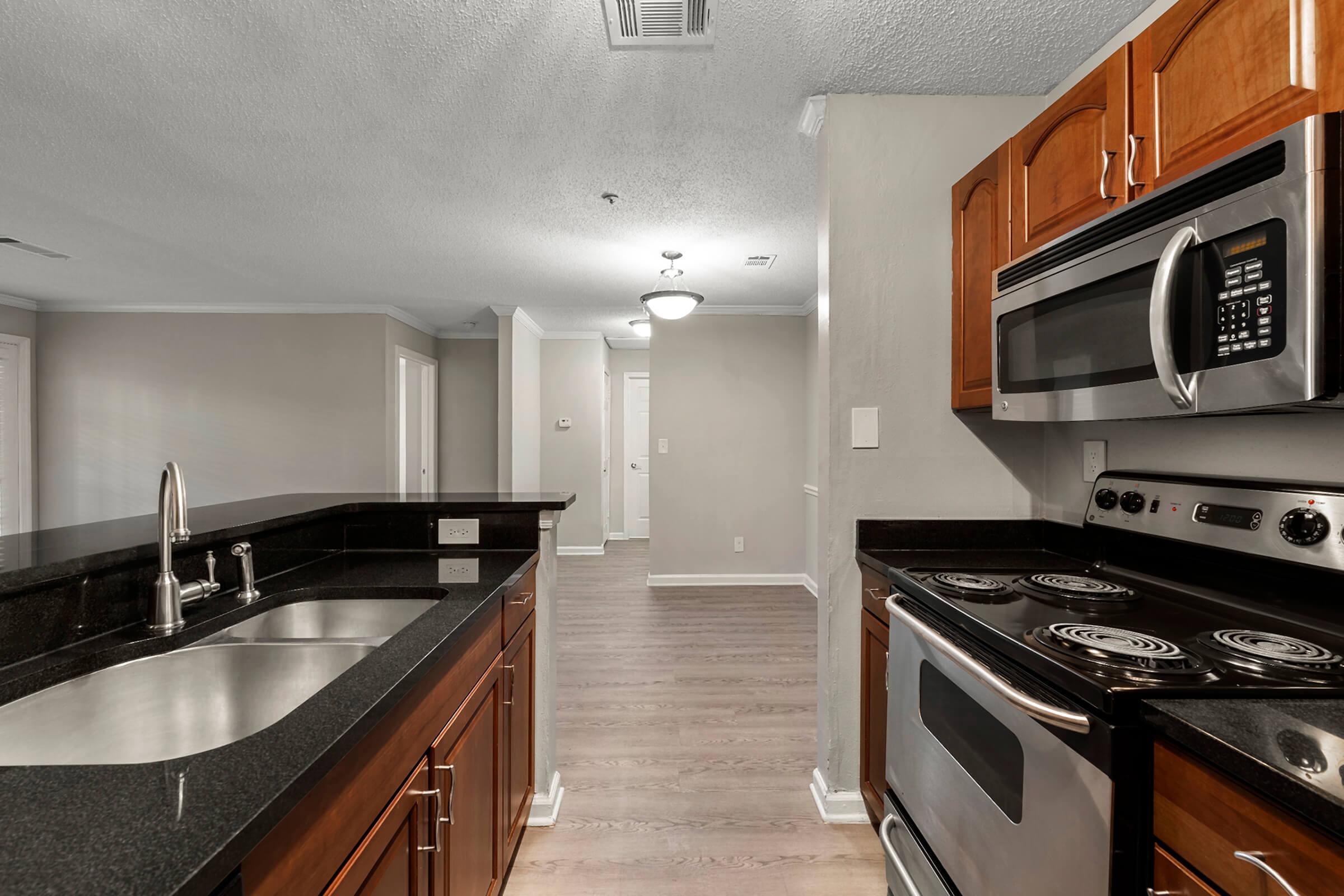 a kitchen with stainless steel appliances and wooden cabinets