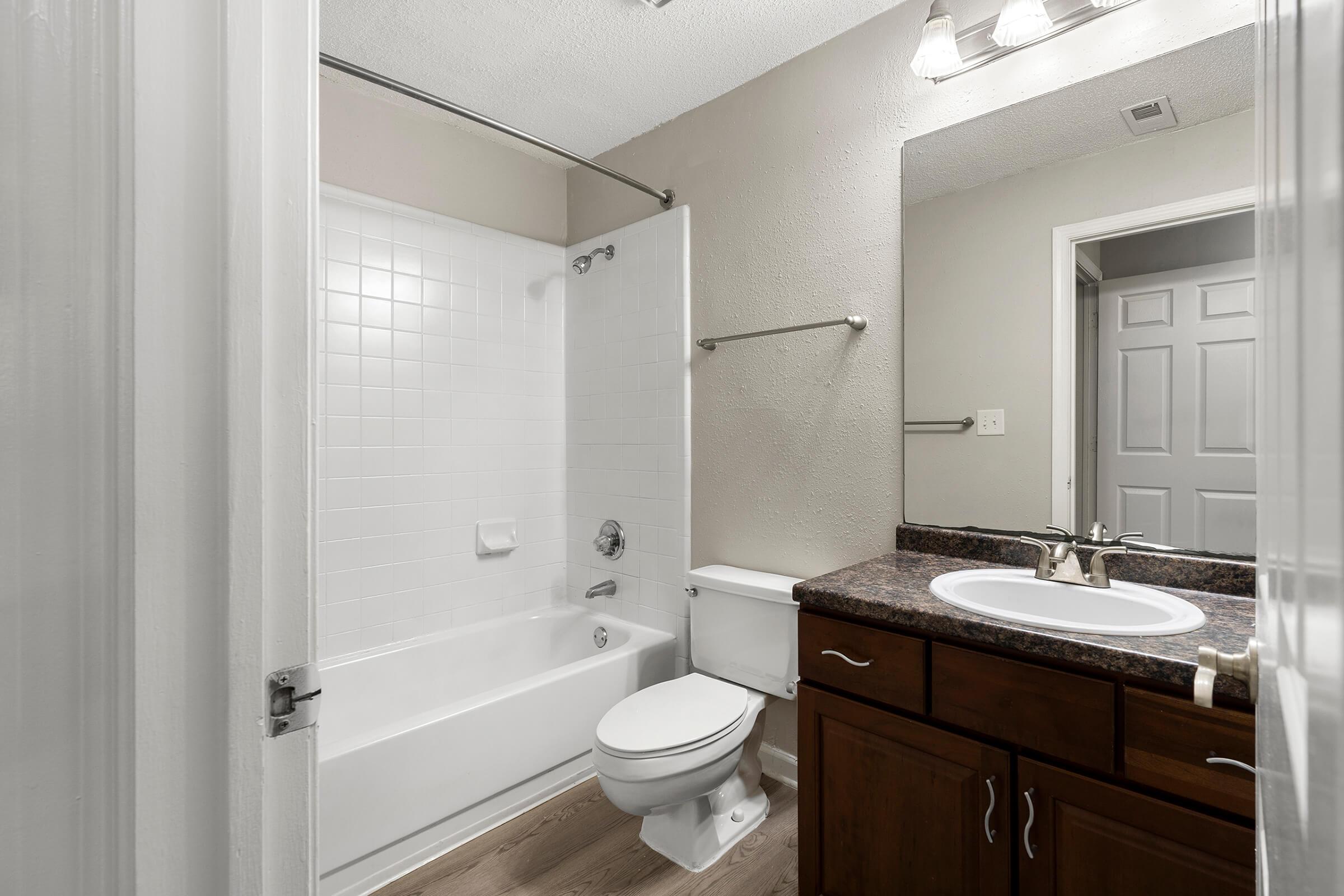 a shower that has a sink and a mirror