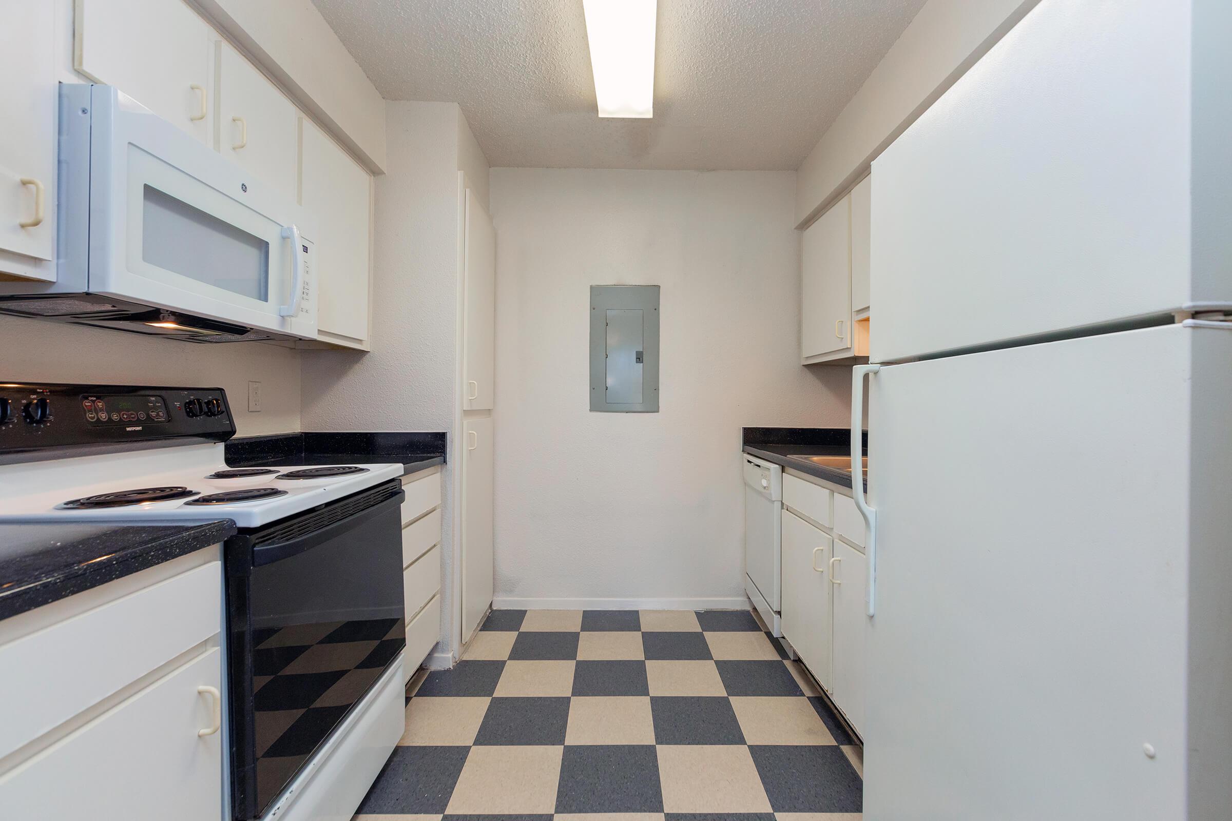 a white stove top oven sitting inside of a kitchen