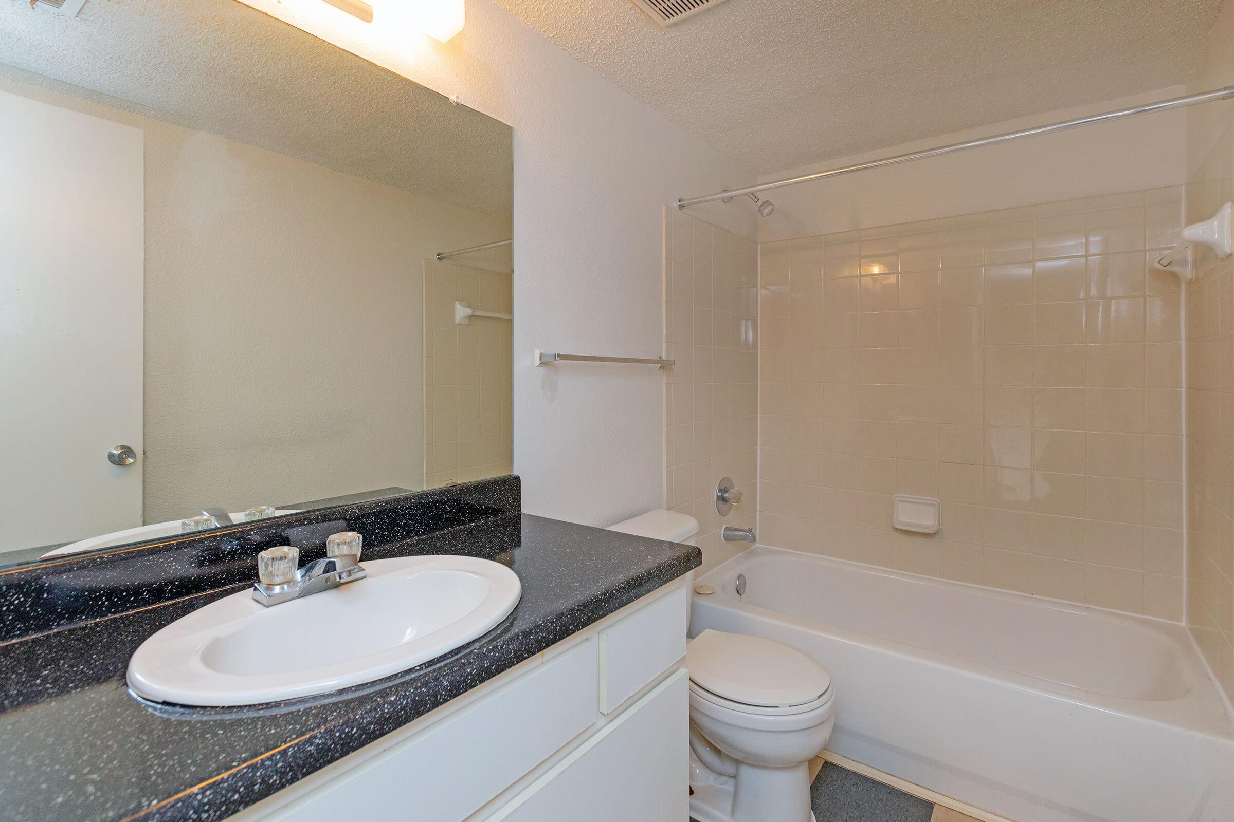 a large white tub next to a sink