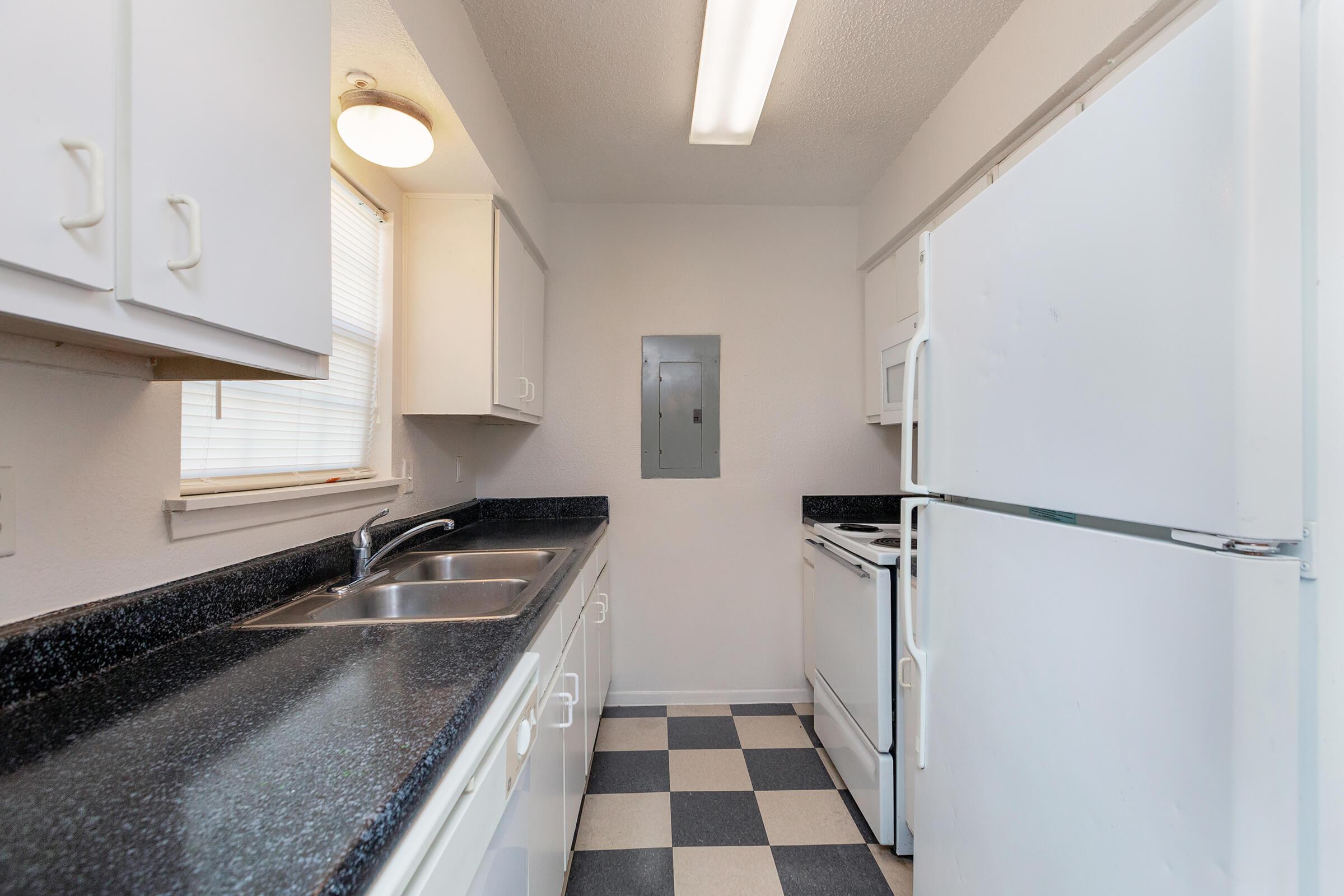 a kitchen with a sink and a refrigerator