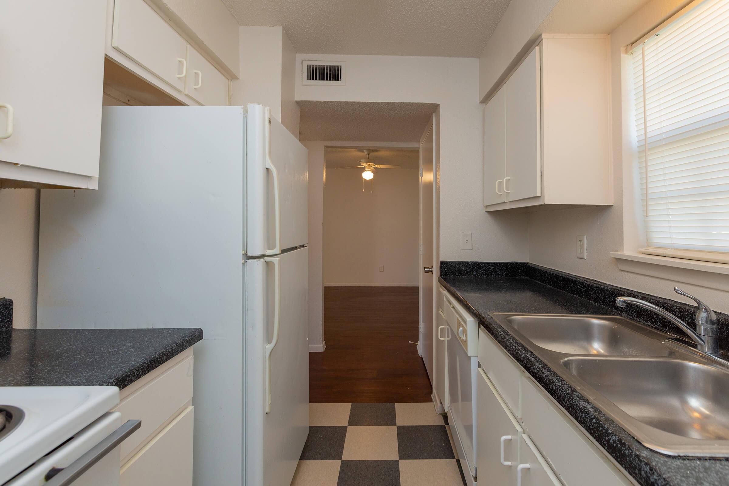 a kitchen with a stove sink and refrigerator