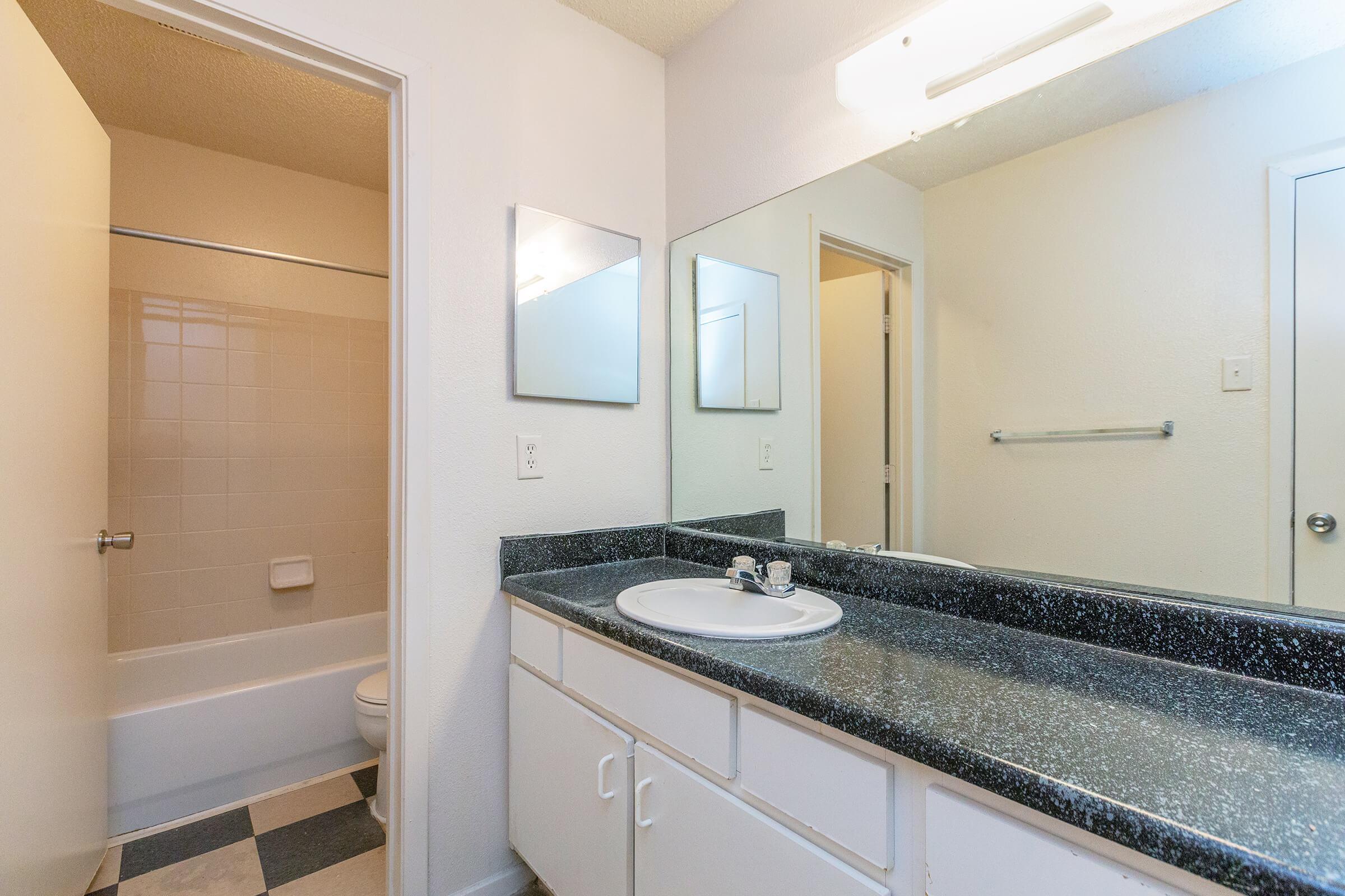 a kitchen with a sink and a mirror