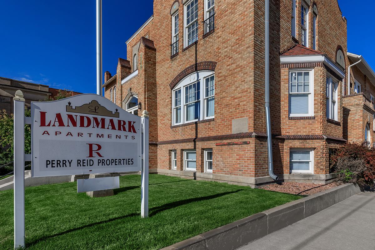 a sign in front of a brick building