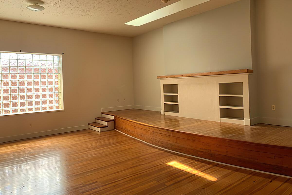 a large empty room with a wood floor