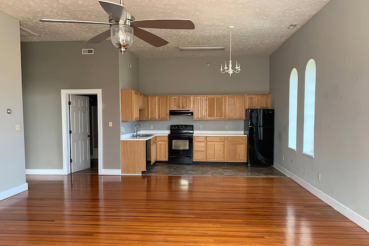 a large empty room with a wood floor