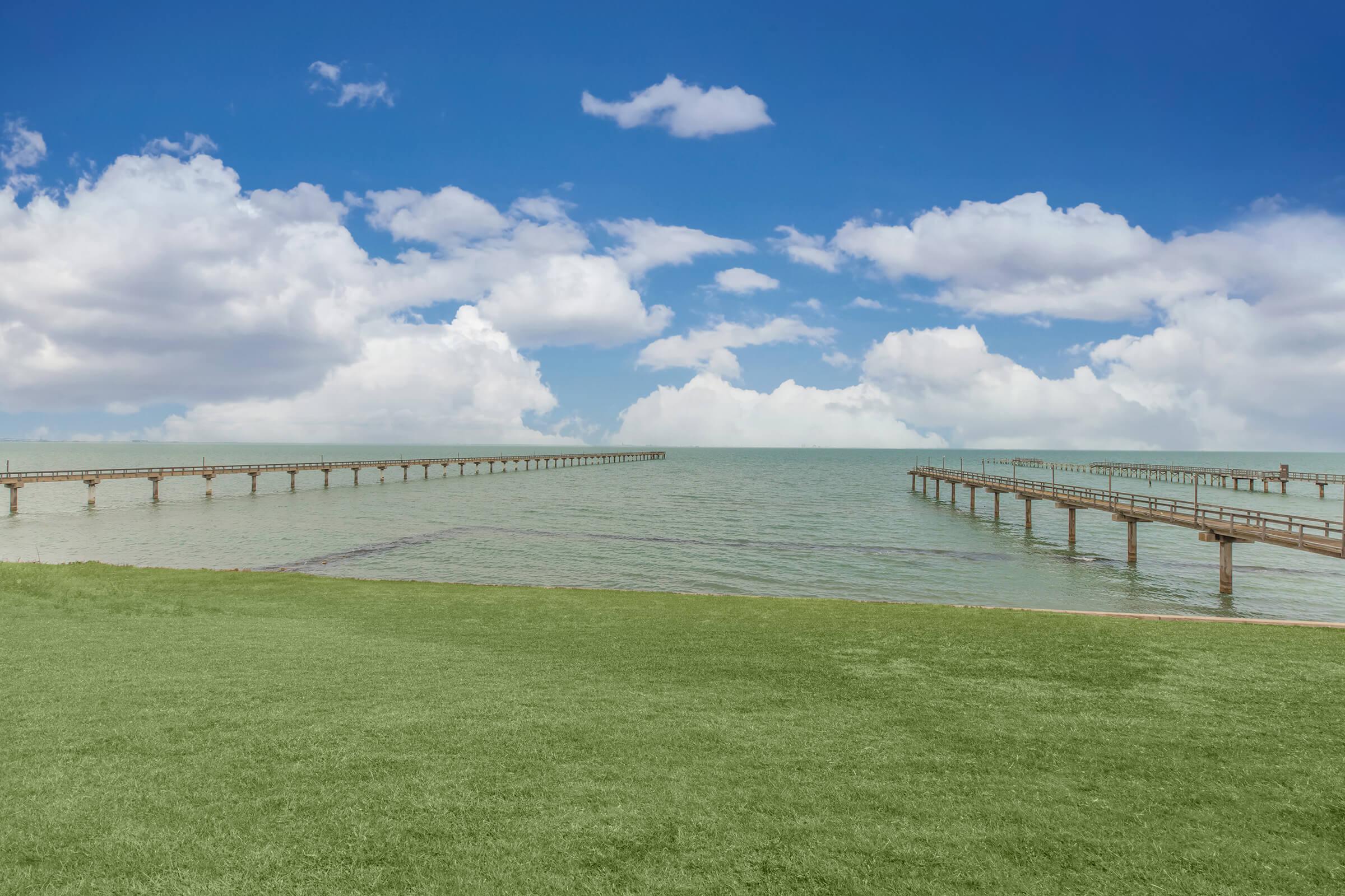 a group of clouds in the sky over a body of water