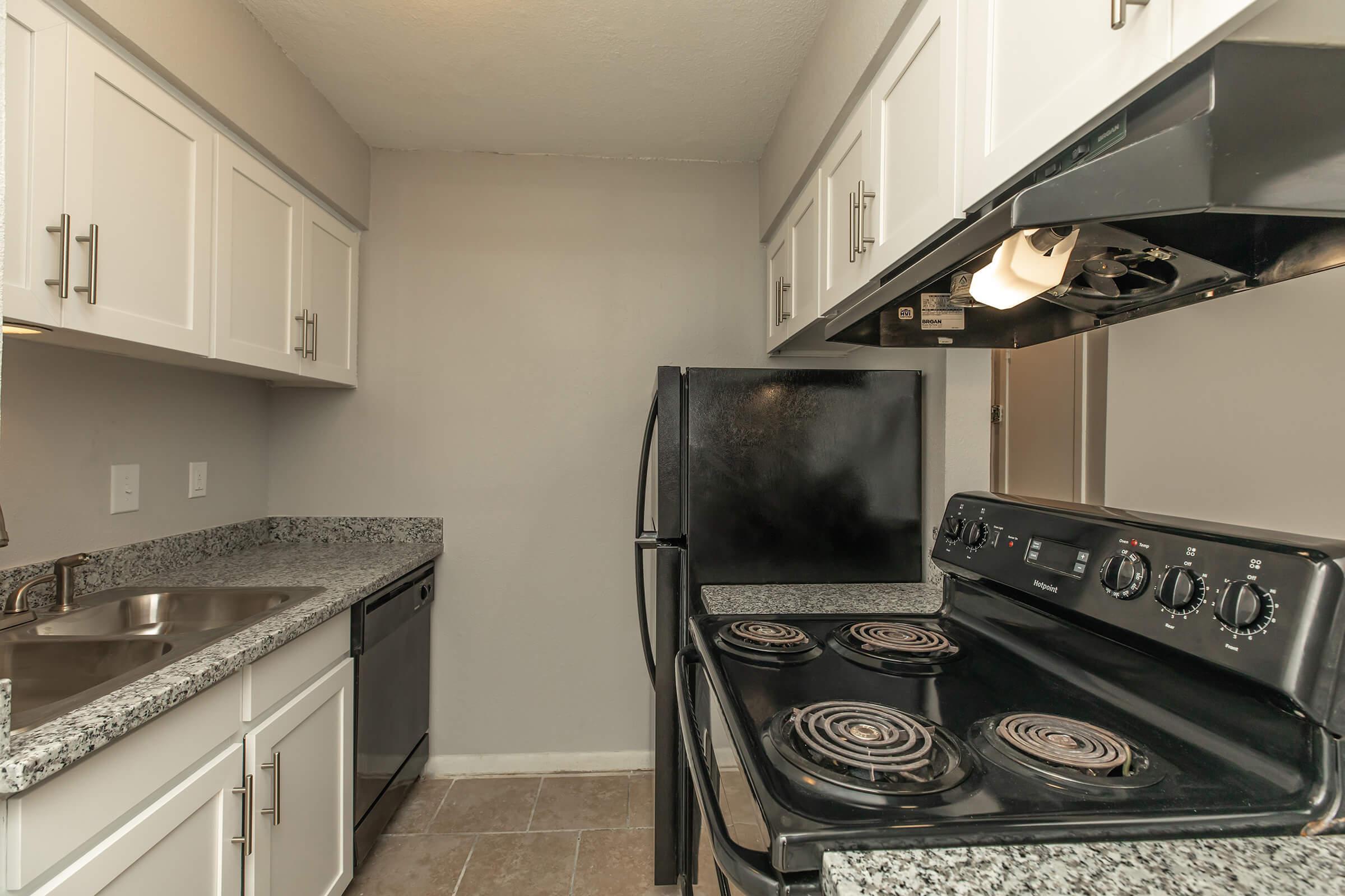 a stove top oven sitting inside of a kitchen