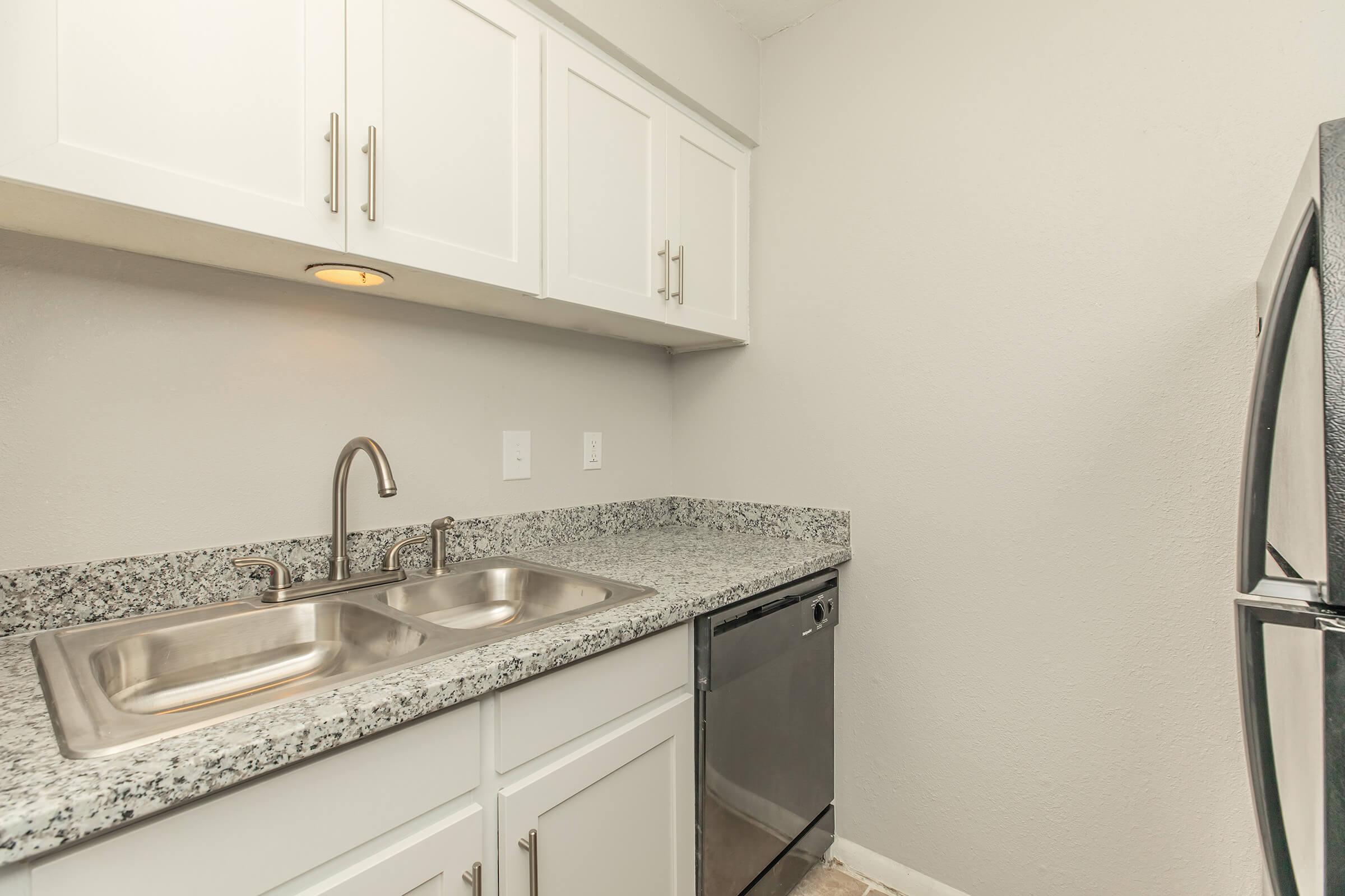 a kitchen with a sink and a mirror