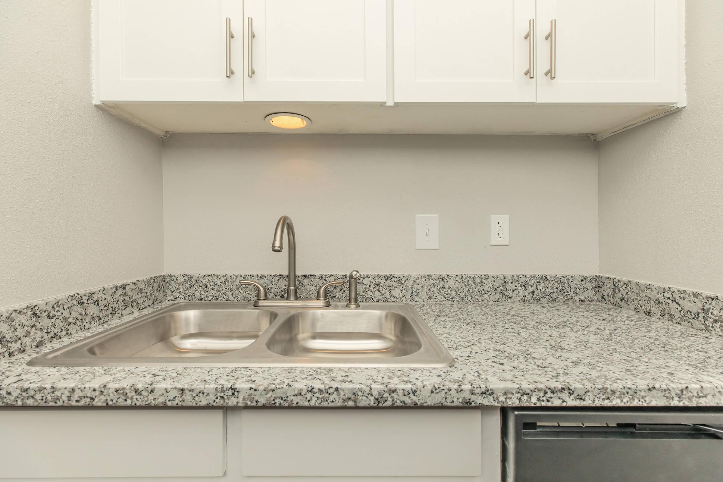 a kitchen with a sink and a microwave