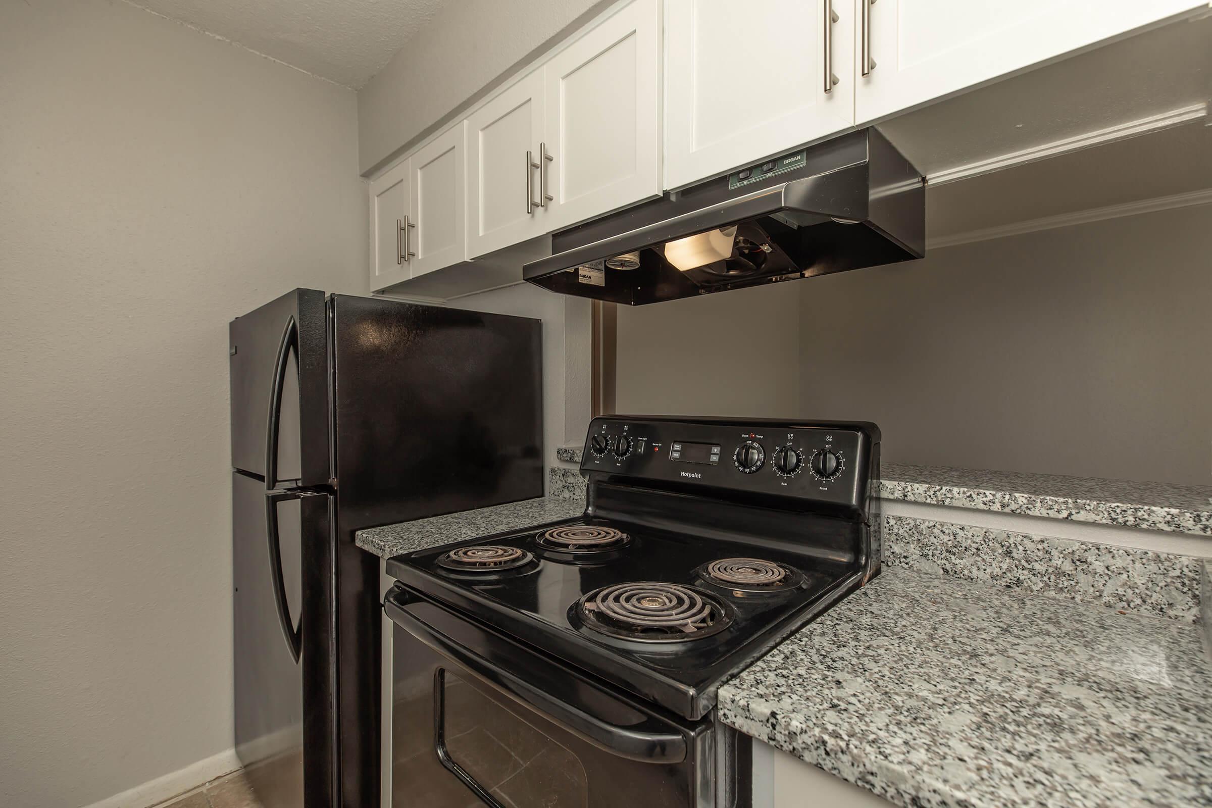 a stove top oven sitting inside of a kitchen