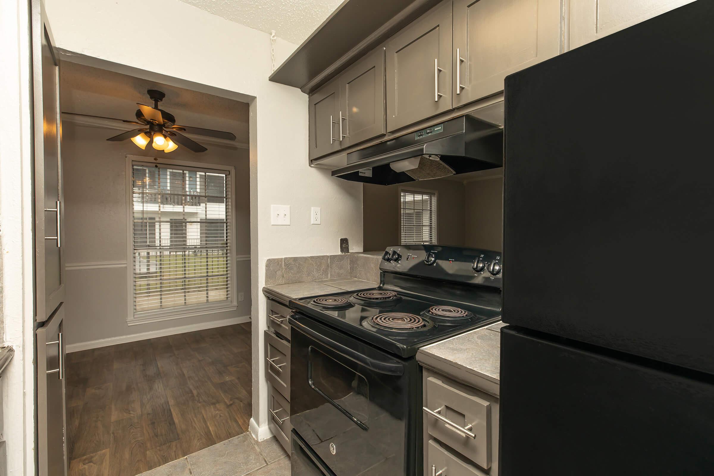 a stove top oven sitting inside of a kitchen