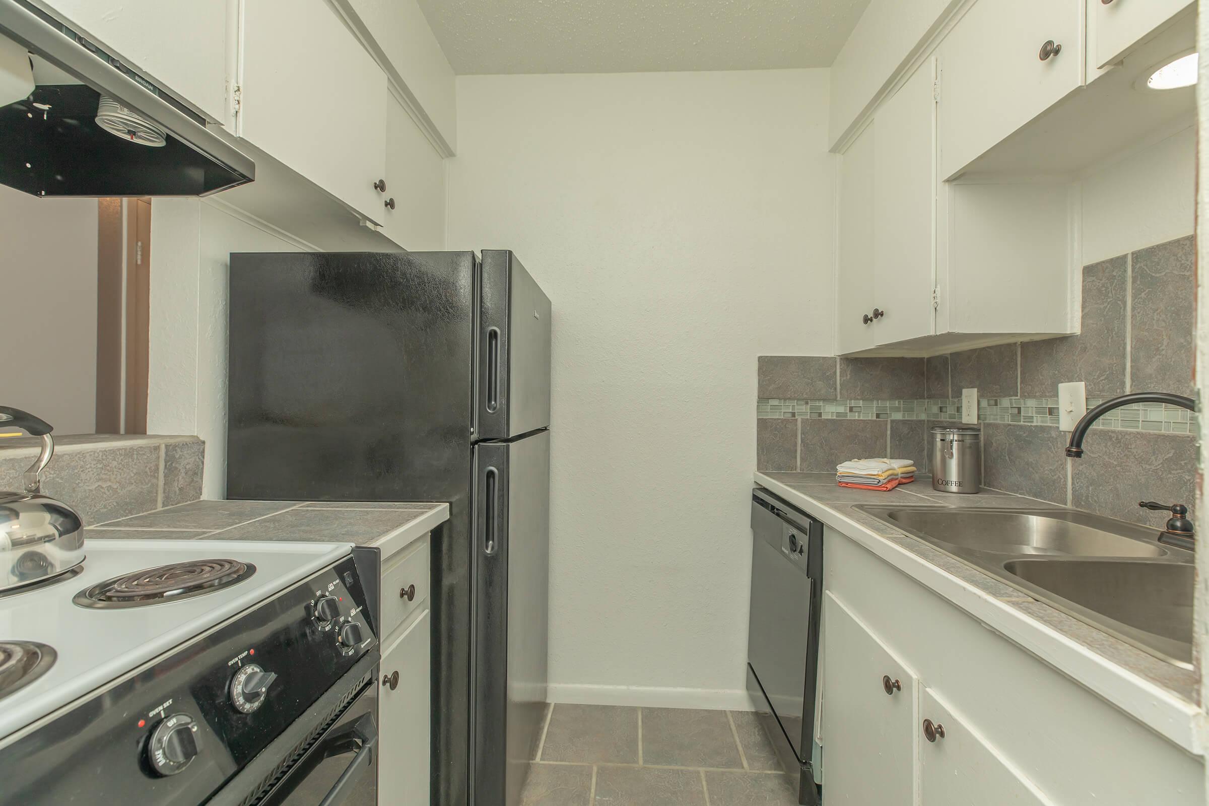 a kitchen with a stove top oven sitting next to a sink