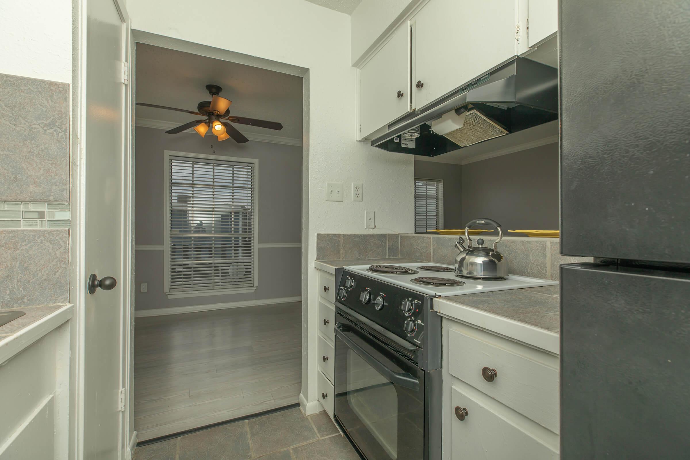 a stove top oven sitting inside of a kitchen