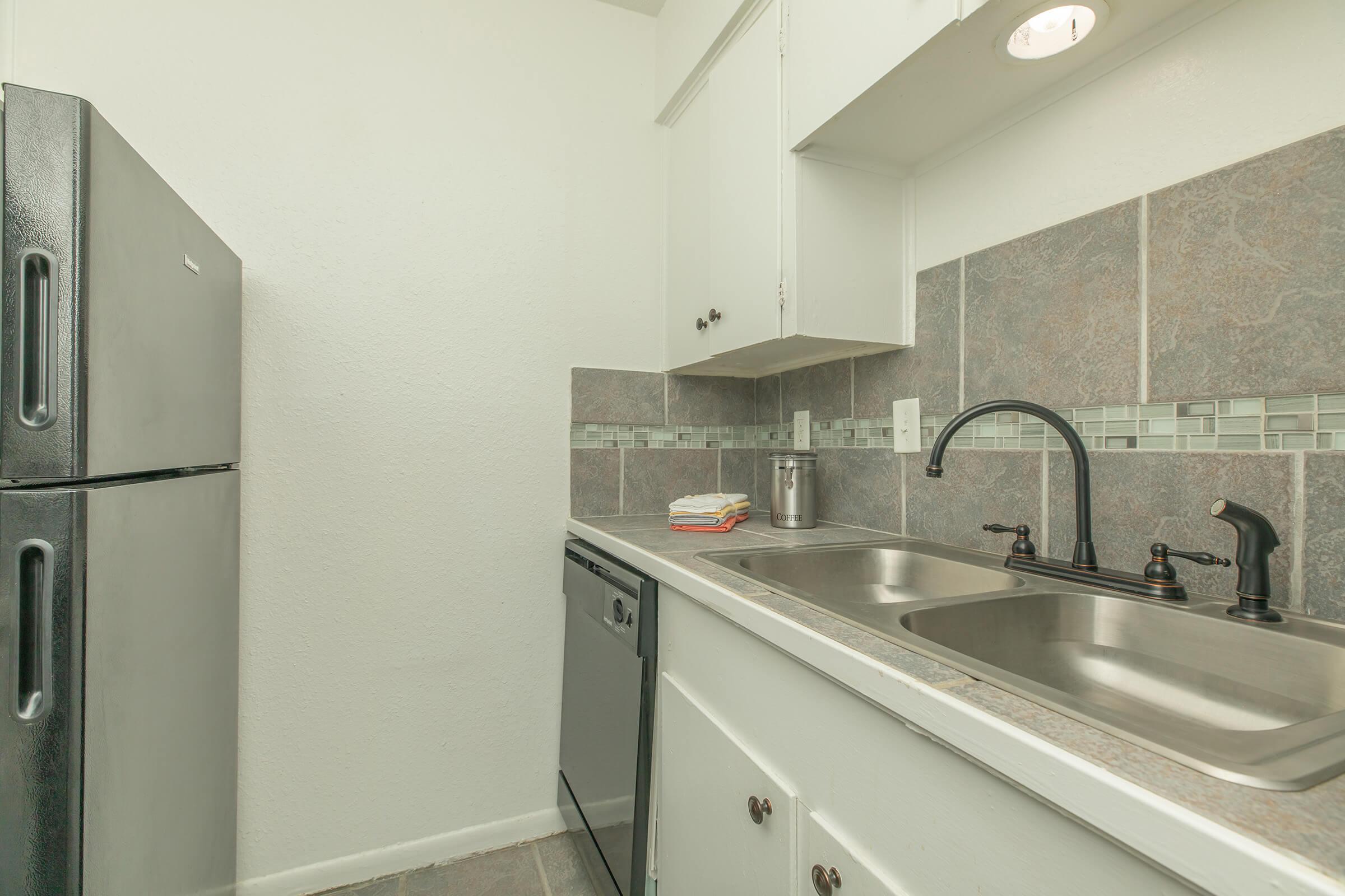 a kitchen with a sink and a refrigerator