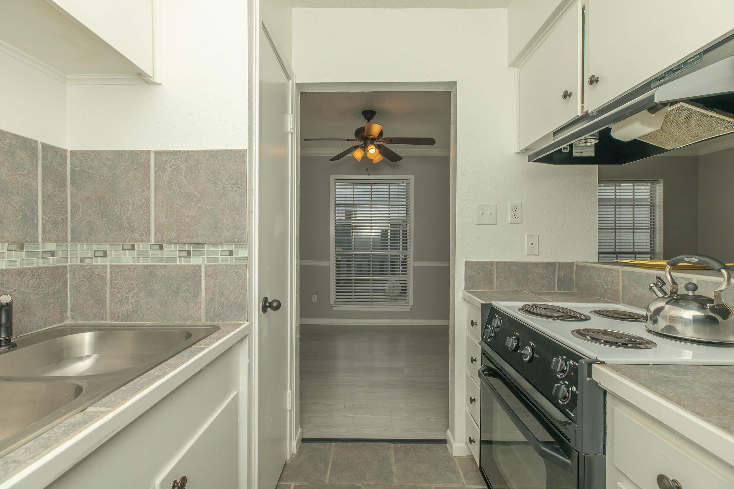 a kitchen with a stove and a sink