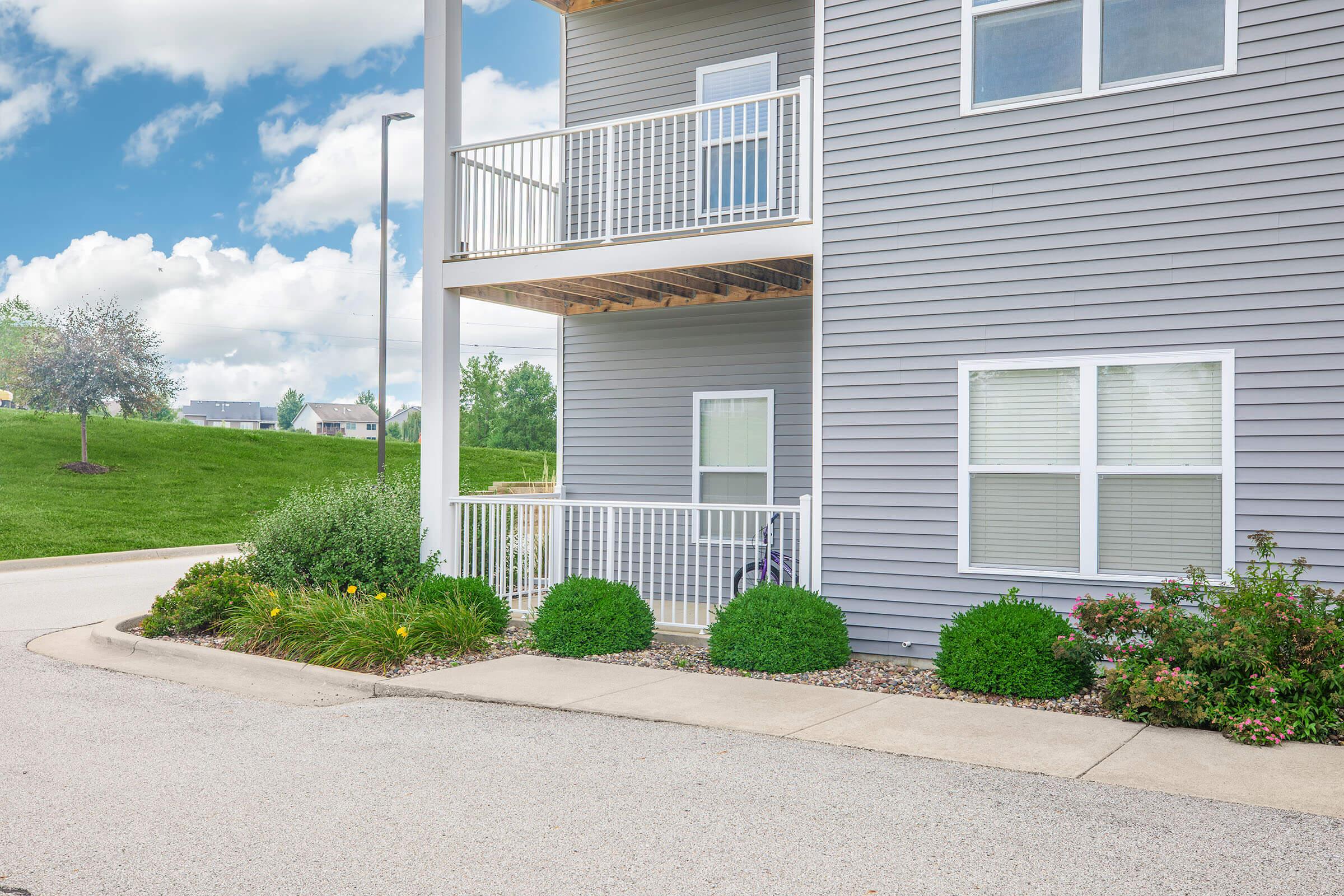 Close-up of balconies and entryway at The Groves on Devils Glen apartments in Bettendorf, IA