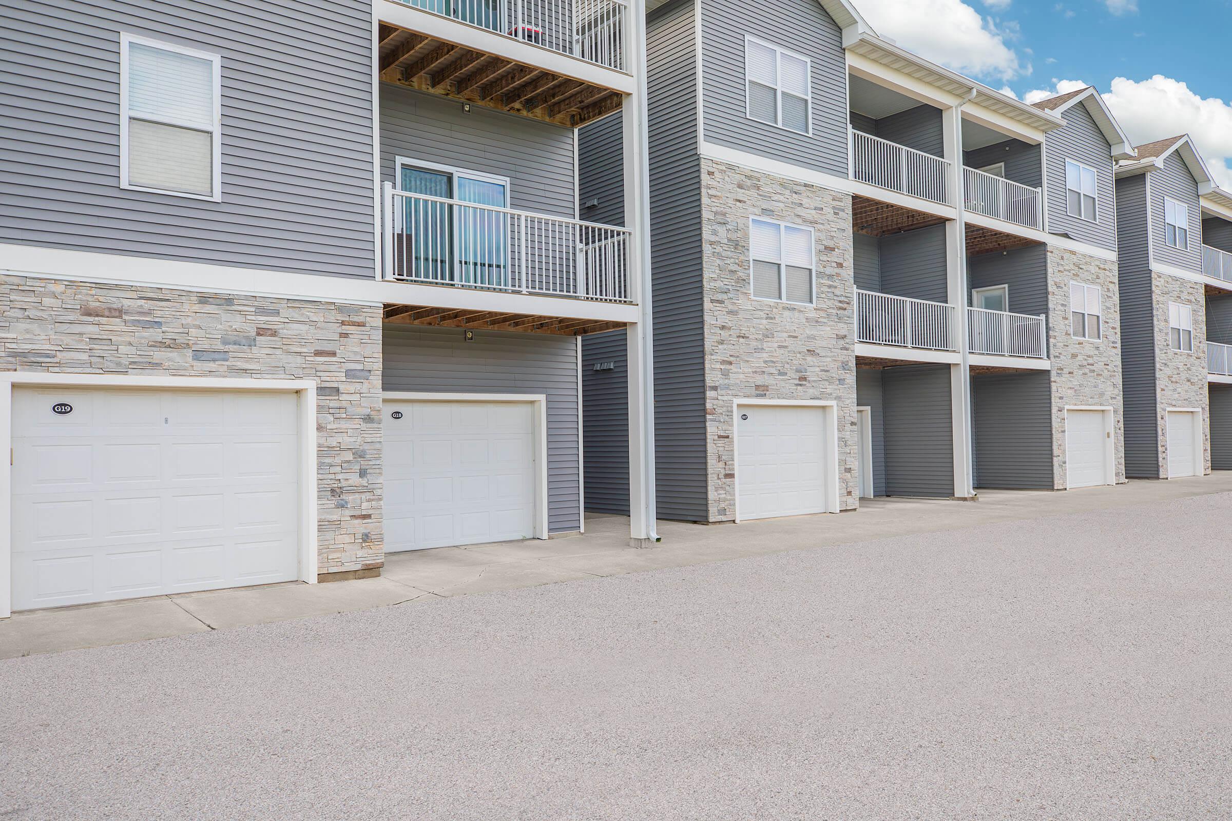 Garage entrances and balconies at The Groves on Devils Glen apartments in Bettendorf, IA
