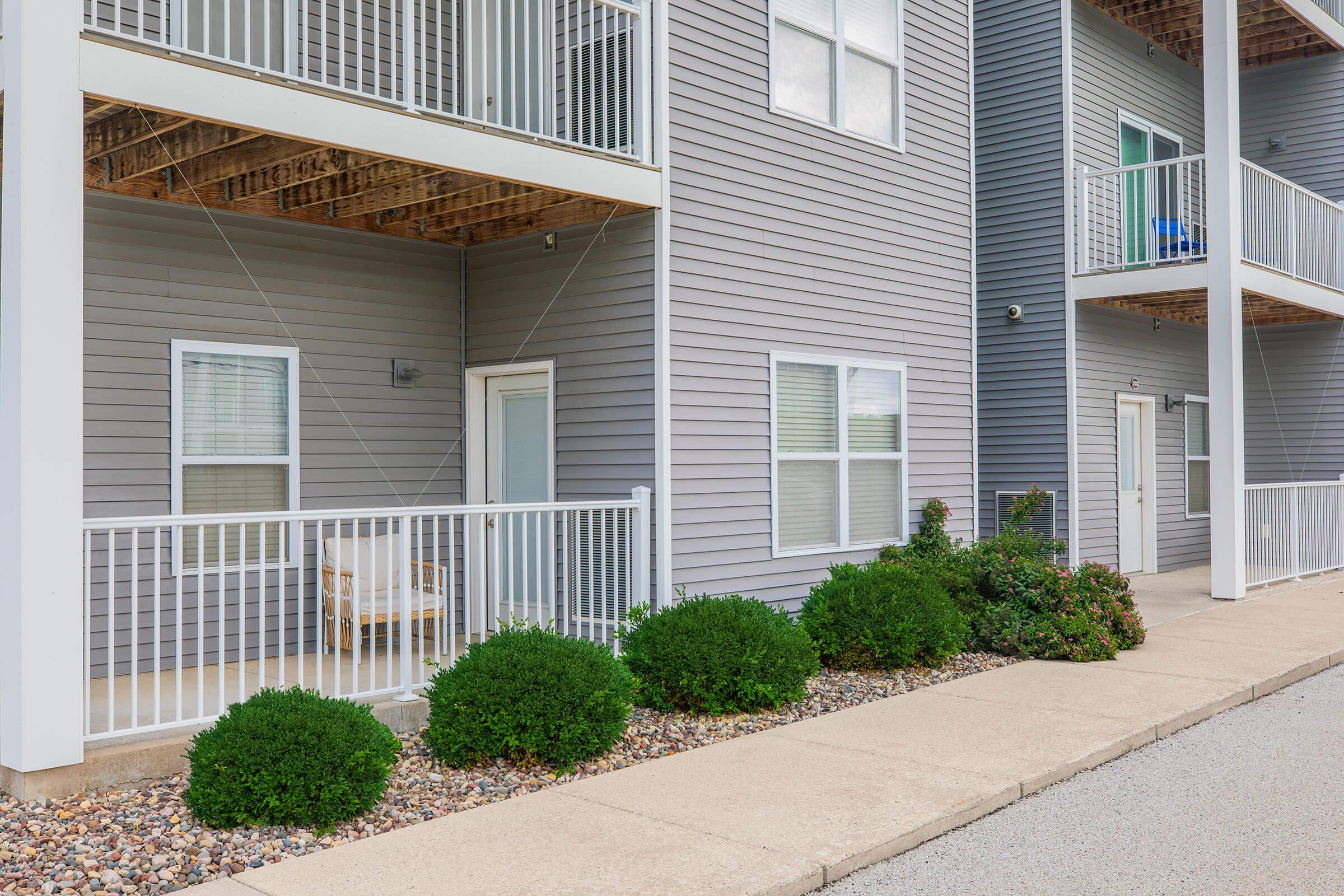 Side walkway and balconies of modern apartments at The Groves on Devils Glen in Bettendorf, IA