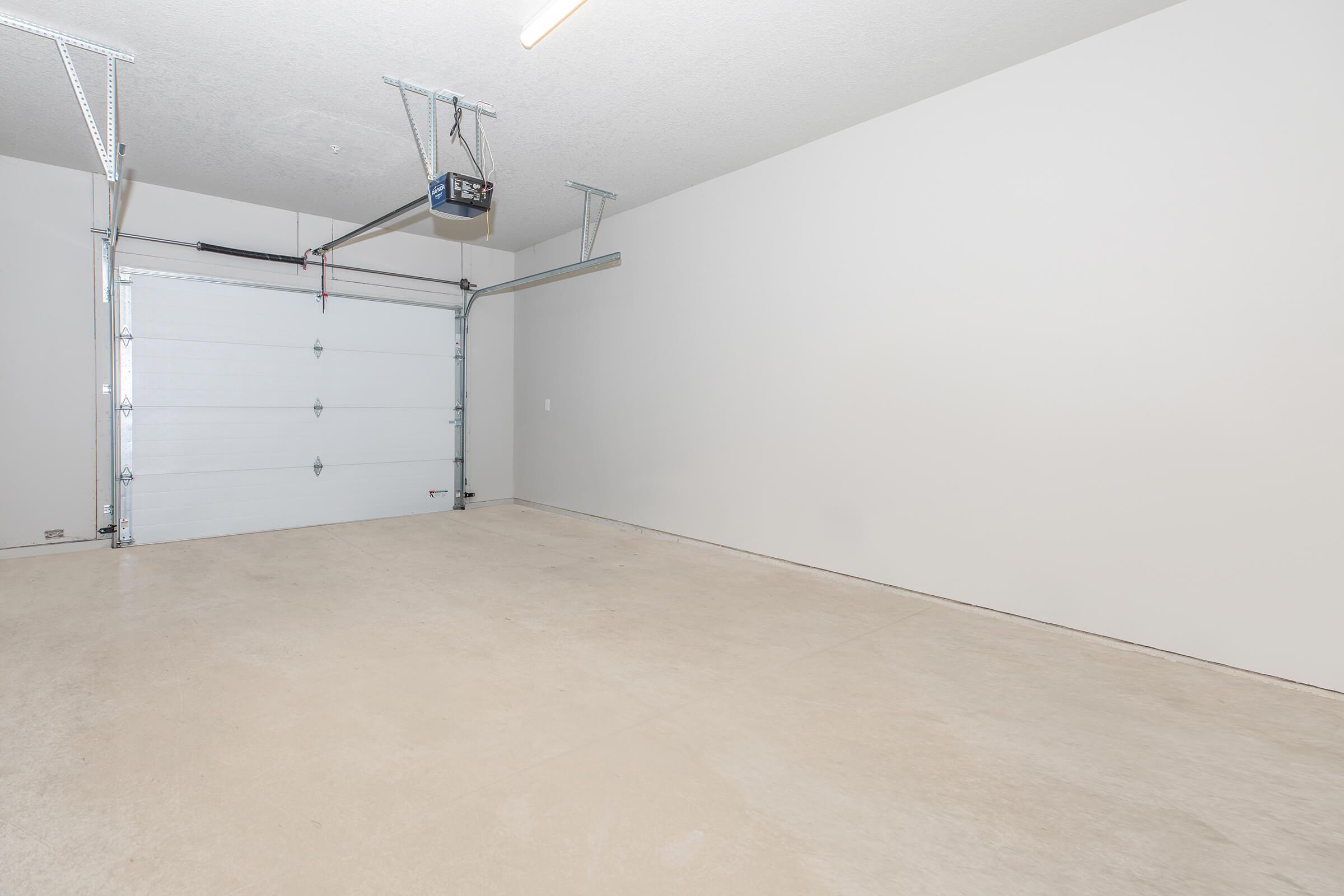 Spacious attached garage with concrete flooring at The Groves on Devils Glen in Bettendorf, IA