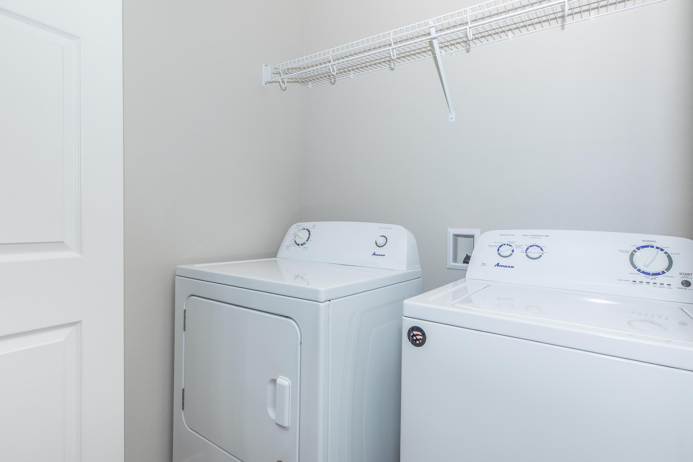 In-home washer and dryer in laundry area at The Groves on Devils Glen apartments in Bettendorf, IA