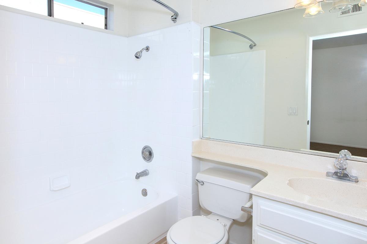 a white tub sitting next to a sink