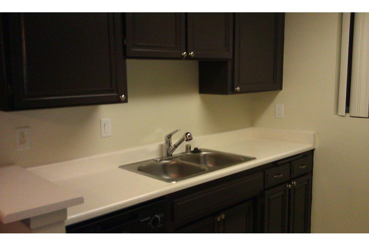 a kitchen with a sink and a microwave